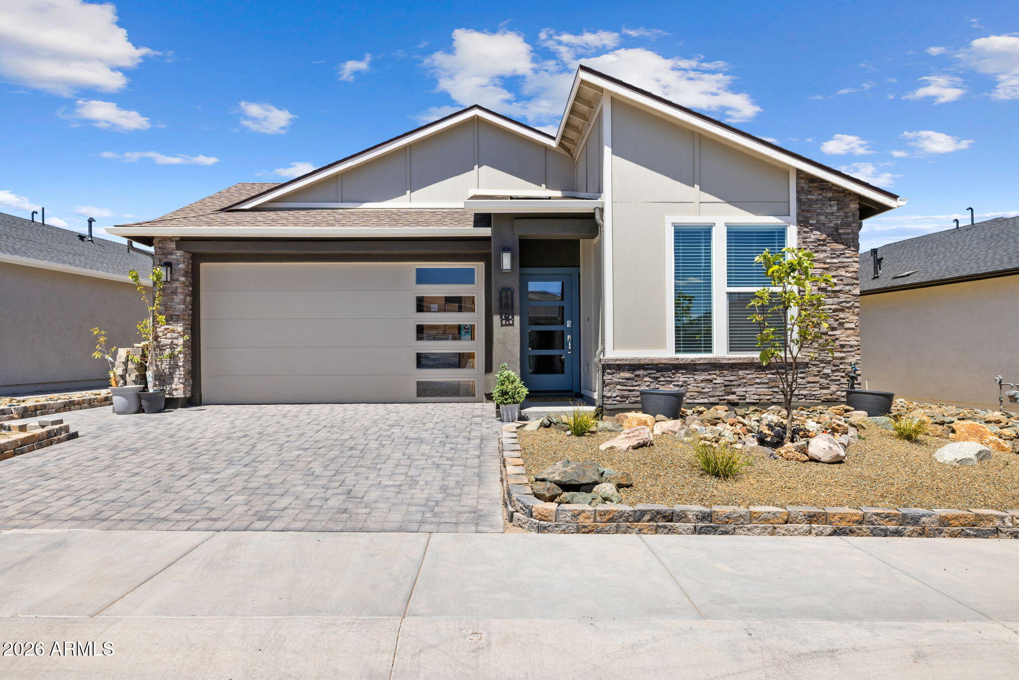 Better than new and ready to show off, this 2025-built South Ranch beauty brings the style, upgrades, and views. With 4 bedrooms, 2.5 bathrooms, and 1,845 sq ft of single-level living, this home knows exactly what it's doing. The stone-and-stucco exterior, glass-panel garage door, paver driveway, and low-maintenance landscaping deliver instant curb appeal with a little swagger. Fresh new interior paint, wireless switches, and a bright modern feel carry inside. The kitchen steals the spotlight with quartz countertops, a huge island, white shaker cabinetry, subway tile backsplash, designer lighting, gas range, and stainless appliances. Then there's the outdoor space: $30K in landscaping, turf, pavers, Granite Mountain stealing the show out back, and Mingus Mountain showing off up front too!