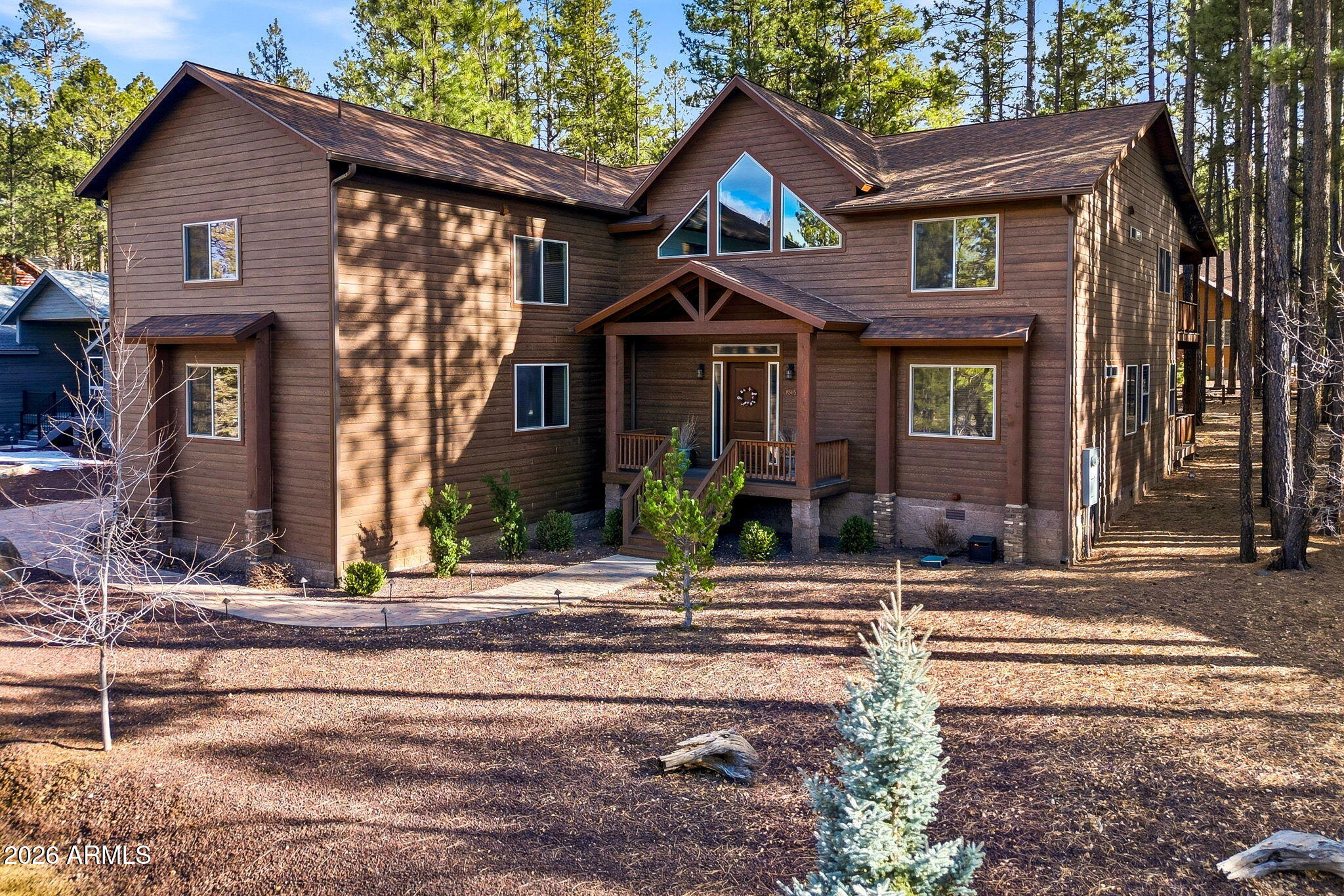 Enquire today for your private tour of this stunning 5-bedroom, 4.5-bath custom home nestled in the highly sought-after Starwood Estates within the prestigious Pinetop Country Club. Ideally situated adjacent to National Forest land, this exceptional mountain retreat offers direct access to endless outdoor recreation including hiking, ATVing, wildlife viewing, and exploring the beautiful White Mountains.

Step inside to soaring vaulted ceilings and a warm, inviting living room centered around a beautiful fireplace with a striking brick-encased mantle, creating the perfect setting for relaxing after a day in the mountains. Large windows invite natural light while framing the serene forest surroundings.