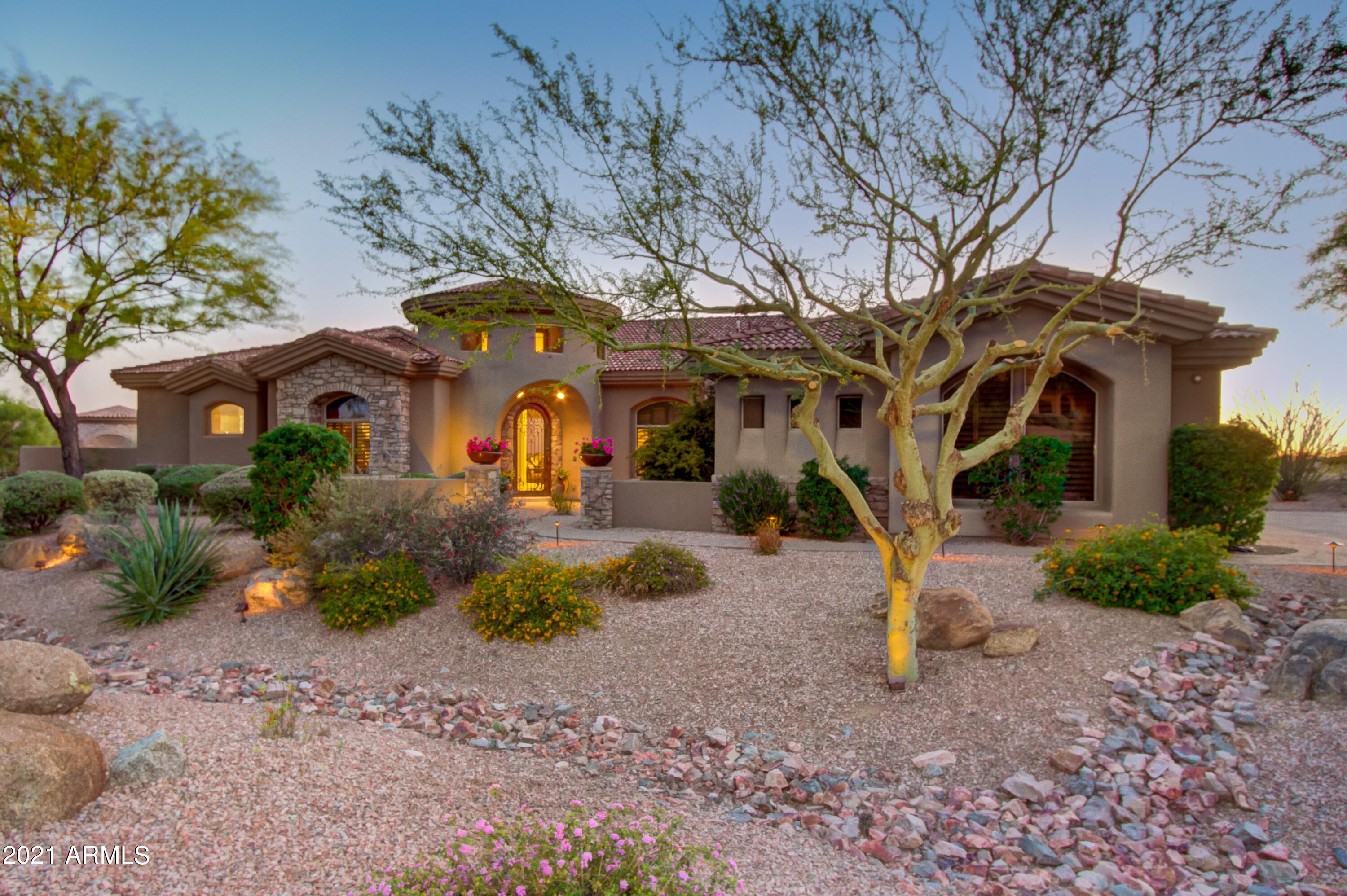 Custom Troon North home located within gated Boulder Crest. This home has incredible views of Pinnacle Peak.  A spacious open floor plan connects kitchen, living and dining with an all-glass view to the back. Custom finishes include hardwood and stone flooring, Wolff/Sub Zero appliances, huge center island, wet bar, wine cooler, state of the art media systems, multiple gas fireplaces and more. The over-sized primary suite is separate and offers his/hers closets. Office/Den with built-in cabinetry. All bedrooms are en-suites. Media room/4th bedroom has Murphy bed, walk-in closet, and full bath. Living is extended to grand outdoor space. Beautiful wood covered patios, with misting system, 2 built in TVs, sound system, putting green, gas fire feature, built-in BBQ and sink. The heated pool, spa and waterfall can be enjoyed by amazing sunsets every night! Close to many golf  courses and Brown's Ranch!