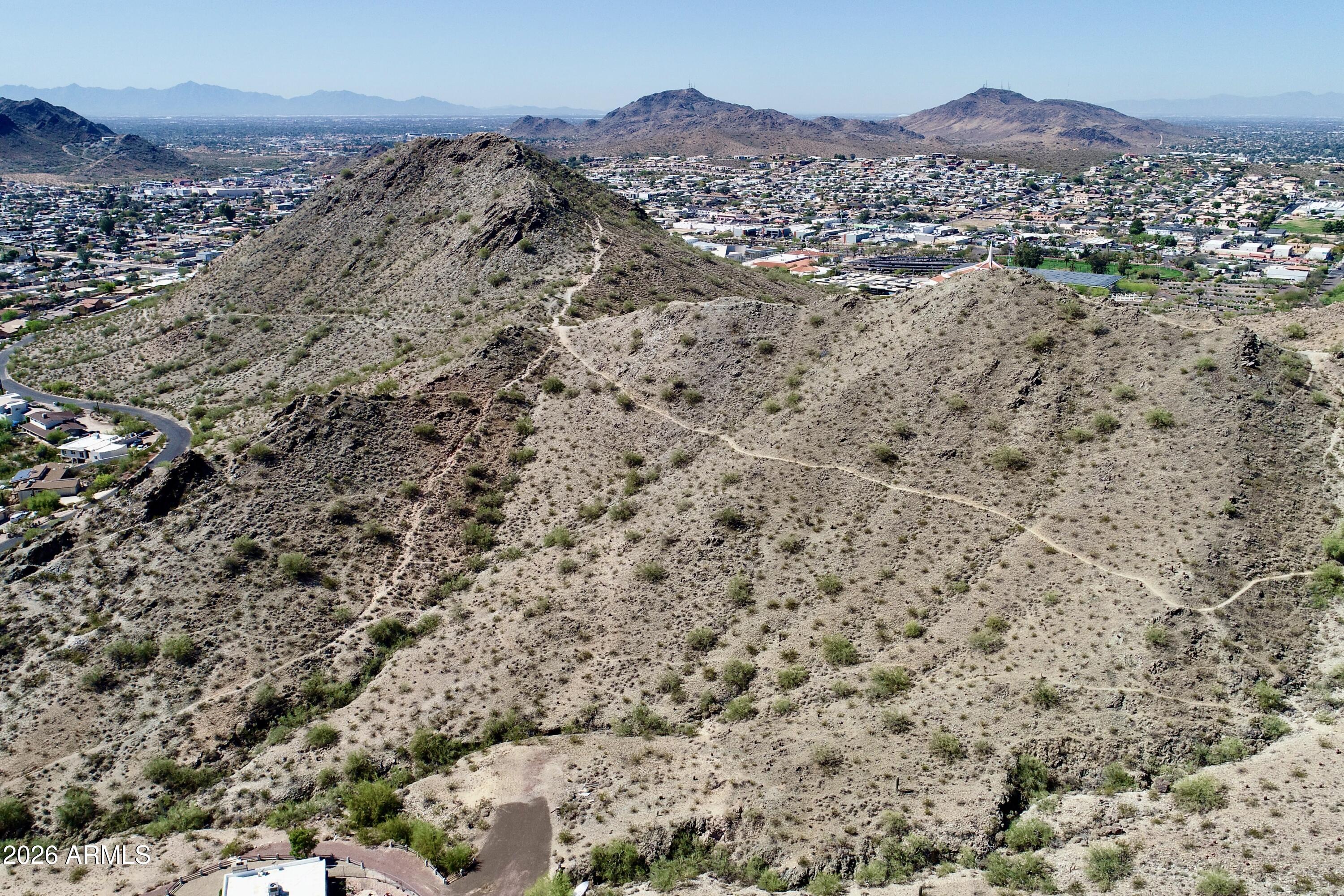 Set on a highly desirable 3.42-acre parcel, this exceptional homesite offers sweeping views of the Preserve at Shadow Mountain, surrounding mountain ranges, and spectacular city lights that illuminate the valley each evening. The elevated setting provides the perfect canvas for a striking luxury contemporary residence designed to capture dramatic desert vistas, glowing sunsets, and panoramic night views.
Ideally located with quick access to the 51 Freeway, the property is just minutes from downtown Phoenix, Sky Harbor Airport, Paradise Valley, and Scottsdale, with premier dining, shopping, and entertainment nearby.
The lot has been surveyed, with power and utilities at the street. Engineering and grading plans are already completed, allowing you to build the sophisticated contemporary residence envisioned in the existing plans or create a custom architectural statement of your own.
An extraordinary opportunity to design and build a modern luxury estate that fully embraces the beauty of the desert, surrounding mountains, and dazzling city lights below.