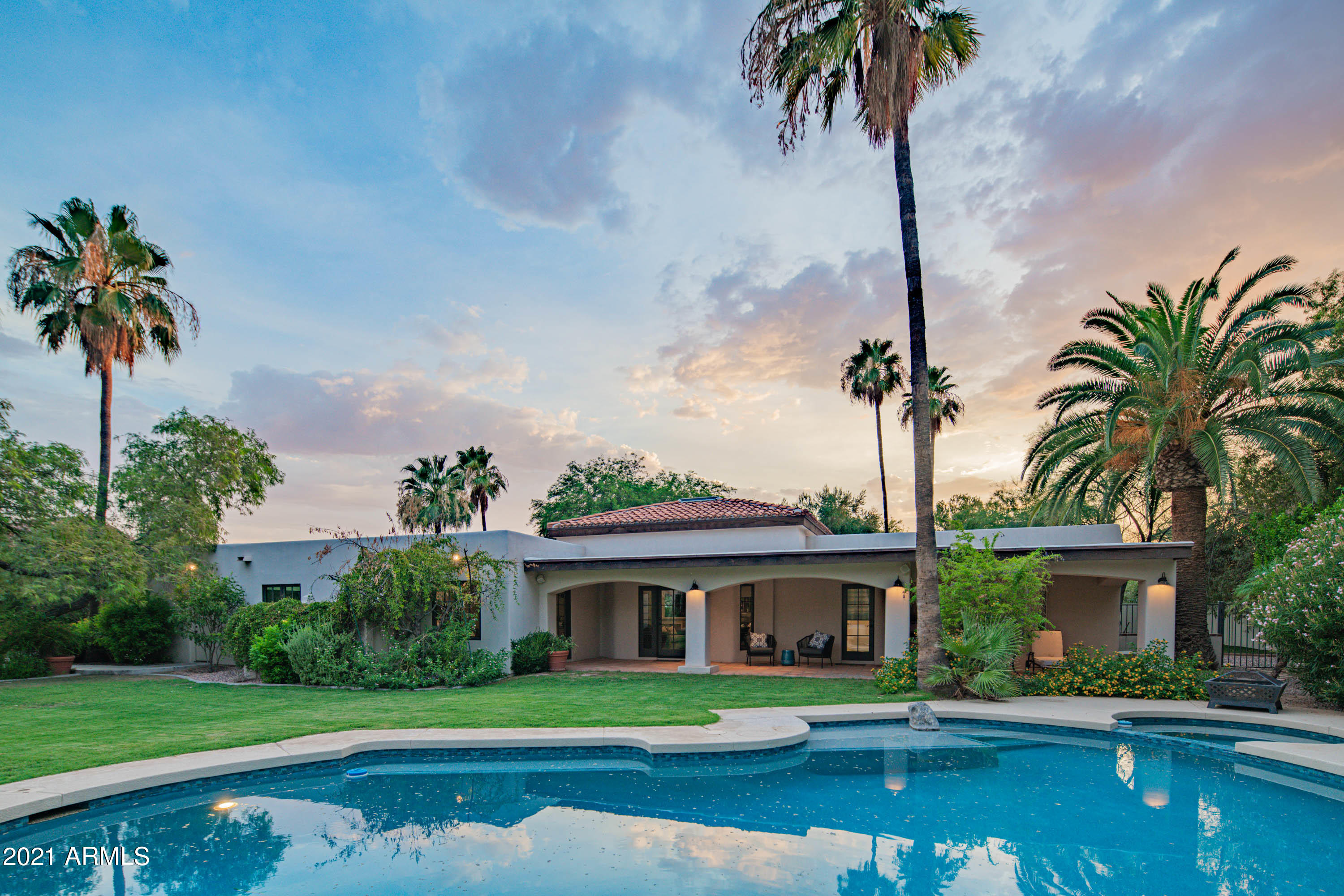 Privately gated and located in an amazing Paradise Valley neighborhood, this oasis in the desert is a real gem. From the moment you enter the charming courtyard you are transported somewhere special. The lush desert landscape and mature shade trees surround you, providing intimate outdoor living spaces. Indoors, the flow is ideal for entertaining with a wonderful family room/living room and chef's kitchen - which leads to another delightful courtyard and grill area. The resort style backyard with sparkling pool, sports court and grassy yard are just ideal for those Arizona summers. Completing the picture, an additional 2570 sq ft detached 6 car garage, guest/flex room and full size RV garage. Located within the desirable 3C's school district this home offers everything you want and more.
