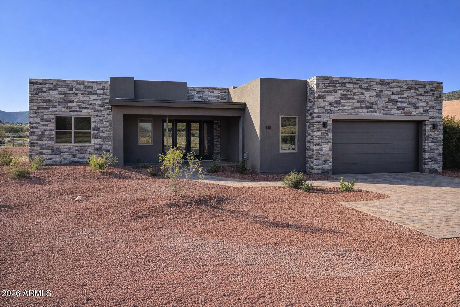 2026 NEW BUILD. Quiet location with panoramic red rock views. This 3-bedroom home features an open great room, 12' sliding glass doors, and covered paver patio. The kitchen includes a large island, quartz counters, stainless appliances, pantry, and breakfast area. The primary suite offers a freestanding tub, tiled shower, and walk-in closet. Premium finishes throughout--porcelain tile floors, matte black fixtures, and designer lighting. Includes oversized garage and stone exterior accents. Enjoy golf, hiking, and Sedona dining minutes away