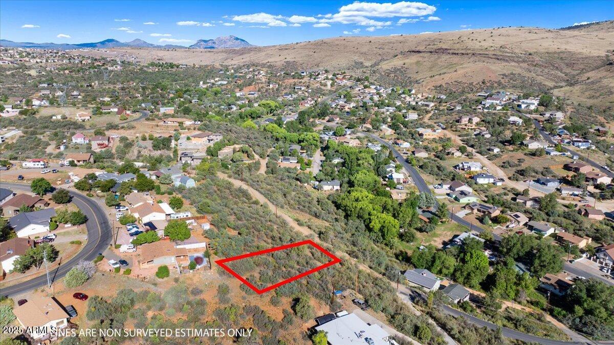 Build your dream home on this beautiful 0.23 acre hilltop lot located in Diamond Valley, one of Prescott's most desirable and centrally located subdivisions. 1627 N Emerald Drive offers breathtaking panoramic mountain views and a private setting that feels like the country, yet keeps you close to shopping, dining, and medical amenities. Nestled on a gently to steeply sloped lot, it provides the perfect elevation for capturing scenic vistas and stunning Arizona sunsets from your future home.

Zoned for site built homes only, this lot is ready for your custom design. Electricity, private water, propane, and cable are available, making future development straightforward. While no utilities are currently installed, the site offers great potential with direct road frontage on a county maintained dirt road. Whether you're planning a primary residence or a peaceful getaway, this location combines convenience with privacy and charm.

No HOA means more flexibility, and with its prime location just 2.6 miles from the Harkins Theater in Prescott Valley and 6.7 miles from downtown Prescott's iconic Whiskey Row, you're never far from entertainment, shopping, and services. Looking for more space? The adjacent lot at 1633 N Emerald Drive is also available, giving you the opportunity to expand your vision and secure even more privacy.

Come see the potential for yourself and envision your future in Prescott's Diamond Valley.