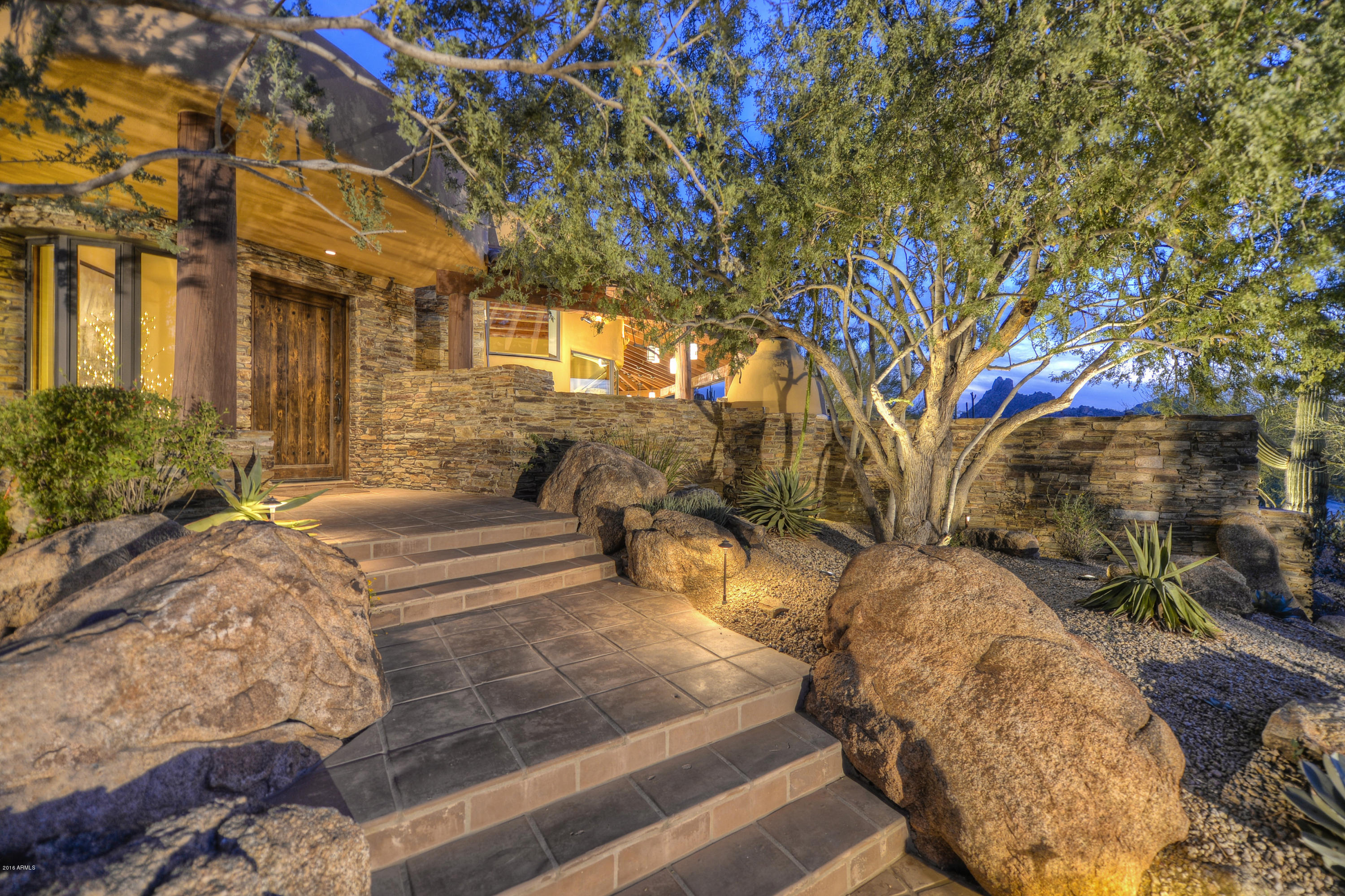 Exceptional southwest contemporary style with sunset and Pinnacle Peak views in Estancia * Just remodeled with leatherized granite counters, hammered copper bar and fireplace surrounds, all light fixtures and multiple built-in millwork pieces * Open, great room floor plan that flows seamlessly for indoor/outdoor entertaining * Interior details include manganese Saltillo flooring, shaker-style cabinetry and Alderwood doors, hand-hewn beams and stacked natural stone * Chef's kitchen with Dacor, SubZero and Asko appliances * Large covered patio with gas fireplace for dining al fresco while enjoying the views * Heated, negative edge pool and spa with large sun deck and gas BBQ complete the outdoor living * Recently added a guest Casita with living room and guest suite plus added a 3rd garage *