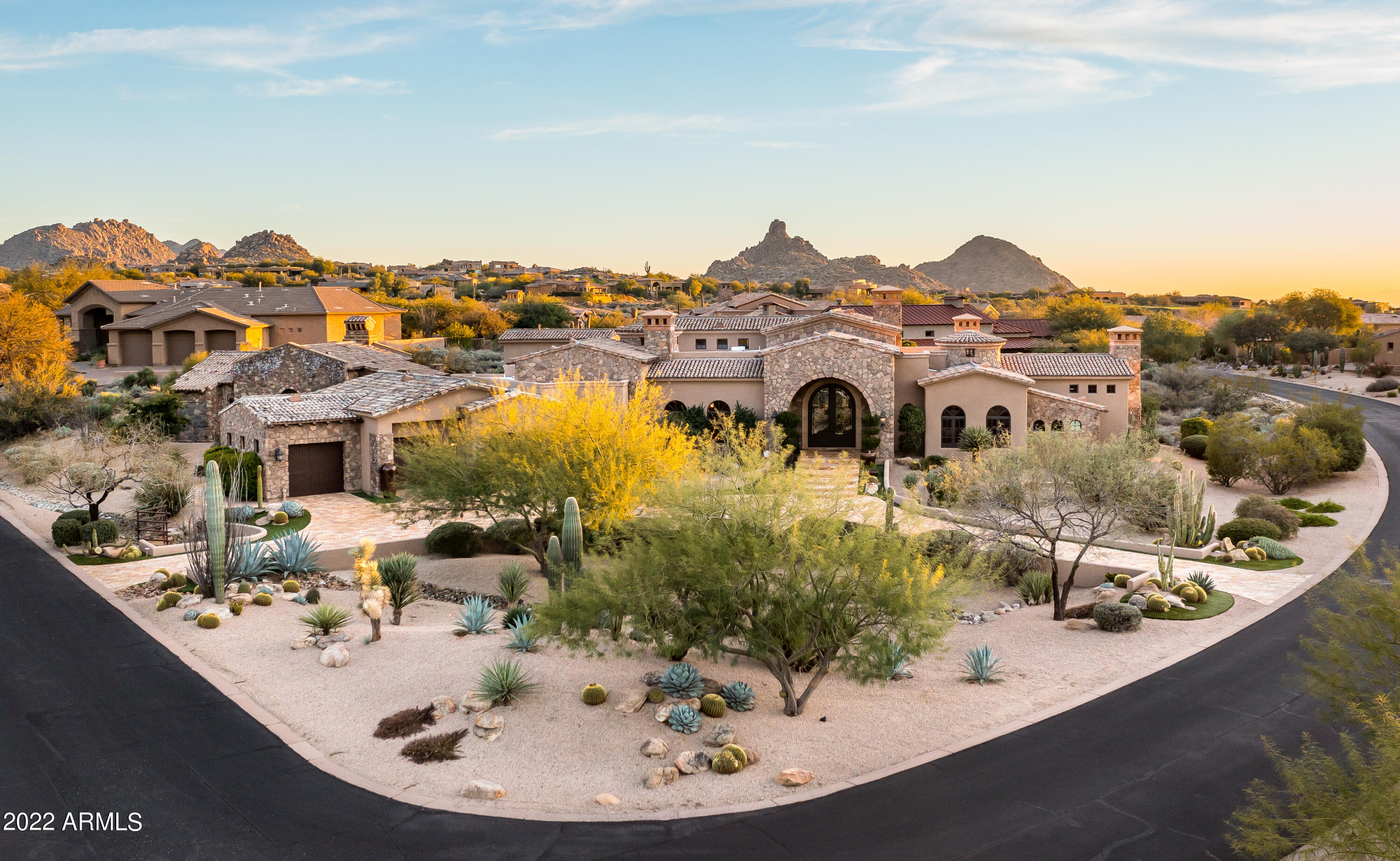 This ''Turn-Key'' property is located on nearly an acre in the heart of Scottsdale. Sprawling at 6,612 sq.ft., this estate boasts 4 bedroom, 5.5 bathroom, contains a grand living space with high ceilings and hand crafted wood beams throughout the home. This luxurious property sits behind the gates of the esteemed Troon golf Community. A dream kitchen, Chef's can only dream of with high end appliances such as Viking, Wolf, Subzero & wet bar. A circular drive to greet your guests as they arrive at an eye-catching terrace garden with beautiful glass double doors. A home perfect for entertaining, especially with a coffered ceiling dining room and a gorgeous fireplace to sit your guests. Master Suite includes a stunning jacuzzi tub parallel to a romantic fireplace, 2 bathrooms and 2 walk-in closets, a shower that includes a steam unit to give a spa ambiance. 7 fireplaces sporadically throughout the home, allowing for a cozy and comfortable living space. As if the above is not enough, the home has an exquisite theater room, temperature controlled walk in wine room, and office/study. Guests will feel right at home in the walkout to the french pocket doors entry to get to the casita, entering into a living area, bedroom with bathroom and full kitchen. Car enthusiasts will marvel at the spectacular detached garage/workshop containing plenty of parking spaces (4 to be exact). The backyard has a resort feel with an outdoor kitchen and oversized patio, glistening pool with both fire and waterfall details.