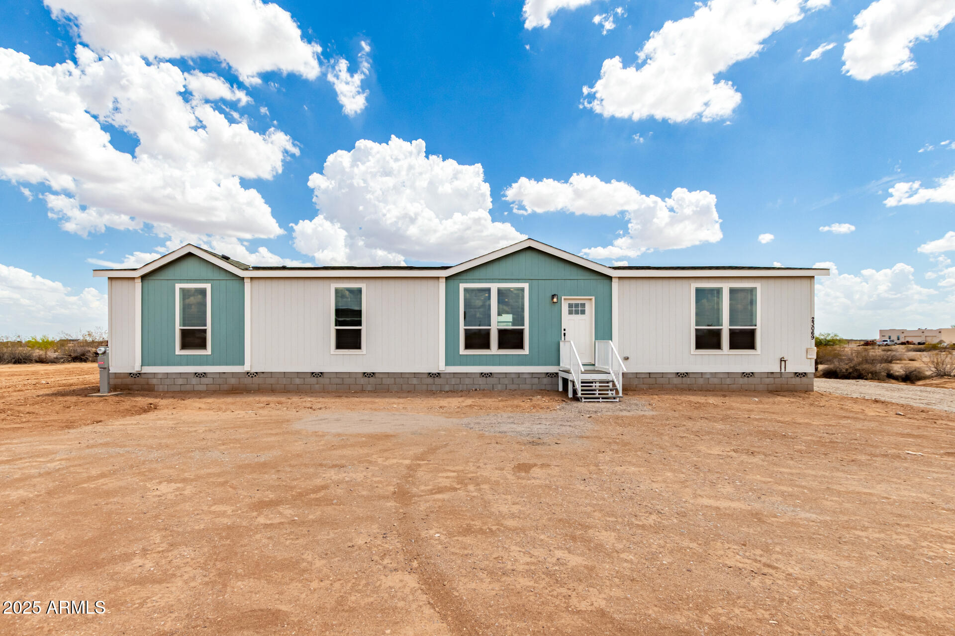 BRAND NEW MANUFACTURED HOME LOCATED ON ONE ACRE LOT IN WITTMANN, AZ. OVER-SIZED 4BR/3BA ''HARMONY'' MODEL WITH 2,160 SQ FT. BEAUTIFUL UPGRADED KITCHEN WITH HARDWOOD CABINETS & SOLID SURFACE COUNTERS. UNIQUE FLOOR PLAN PROVIDES PLENTY OF SPACE FOR A LARGE FAMILY OR HOUSE GUESTS. HOME OFFERS A MODERN DESIGN & NEUTRAL COLOR SCHEMES WITH 9FT FLAT CEILINGS. HOME IS GROUND SET & HAS 2 X 6 CONSTRUCTION. CONVENIENT LOCATION JUST NORTHWEST OF THE PHOENIX AREA AND NEAR THE US60/GRAND AVE.  NO HOA! 5-WAY SHARED WELL. ENJOY THE WIDE OPEN DESERT WITH BEAUTIFUL VIEWS! *UP TO $8,000 TOWARDS BUYER'S CLOSING COSTS INCLUDED*