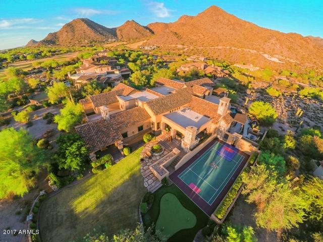 This Salcito Custom Home built treasure has so much diversity that it's a MUST SEE! The game room, sport court, play pool, putting green, lawn, theater room & open-floor plan living spaces make it perfect for families.  4+ private outdoor living areas with city and mountain views, formal bar, house music, wine storage, 4 fireplaces and a firewall provides entertainment of large or small groups in style and intimacy.  You can sneak away to the master retreat, an outdoor shower and spa, the loft with player piano, or the outdoor hideaway living room. a privacy buffer supplied by the wash. Livable, covered area and terraces total nearly 15,000 square feet!

The home is nestled perfectly at the edge of a cul-de-sac on 1.4 acres. Located in-between holes 15 and 16 of the DC Ranch Golf Course. The home offers 6/7 bedrooms-many with decks or balconies, 7 1/2 bathrooms, large workout room, theater, 3-level pool/BBQ area, 2 offices, 3 dishwashers, secure dog run, built-in safe, huge storage areas, and garages for 5 vehicles, including a dual extended-height garage.  Many other amenities available!

This home has something for everyone!