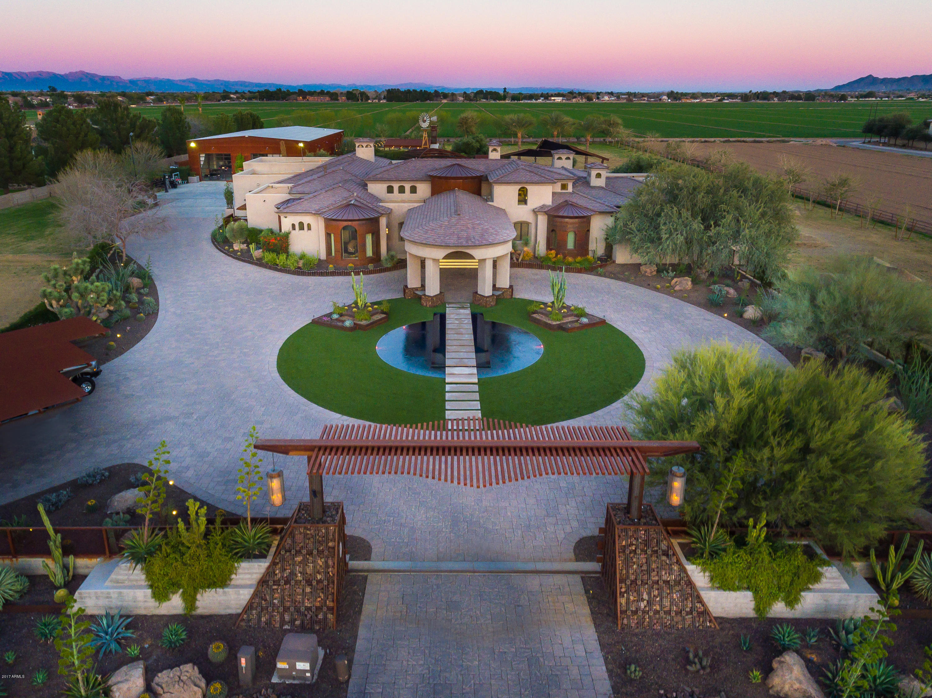 Priced under appraisal! Absolutely extraordinary in every way, this stunning estate is highlighted by a magnificent main house (5 bedrooms; 4 full baths; 2 half baths; 9,326 square-feet) dressed with a wealth of rustic wood, leather-clad walls, a two-story “hers” dressing closet w/sliding ladder, and more. In addition, a massive multi-purpose building with approximately 5,628 livable SF boasts a batting cage, a game room, fitness center, kitchen and casita. Alfresco amenities include 2 water features, 4 generous-sized covered patios, elegant pool, spa and splash pad area, swim-up stools to barbeque island/bar, in-ground trampoline, soccer field/playground, windmill, fire-pit, garden and more. A small sampling of the main home's highlights includes trestle-beamed ceiling motifs, rustic wood beams that were assembled on site, copper clad exterior portions, a fantastic stove-range that includes electric, gas and grill, dual master baths with private meditation gardens, and exquisite exterior metal work.