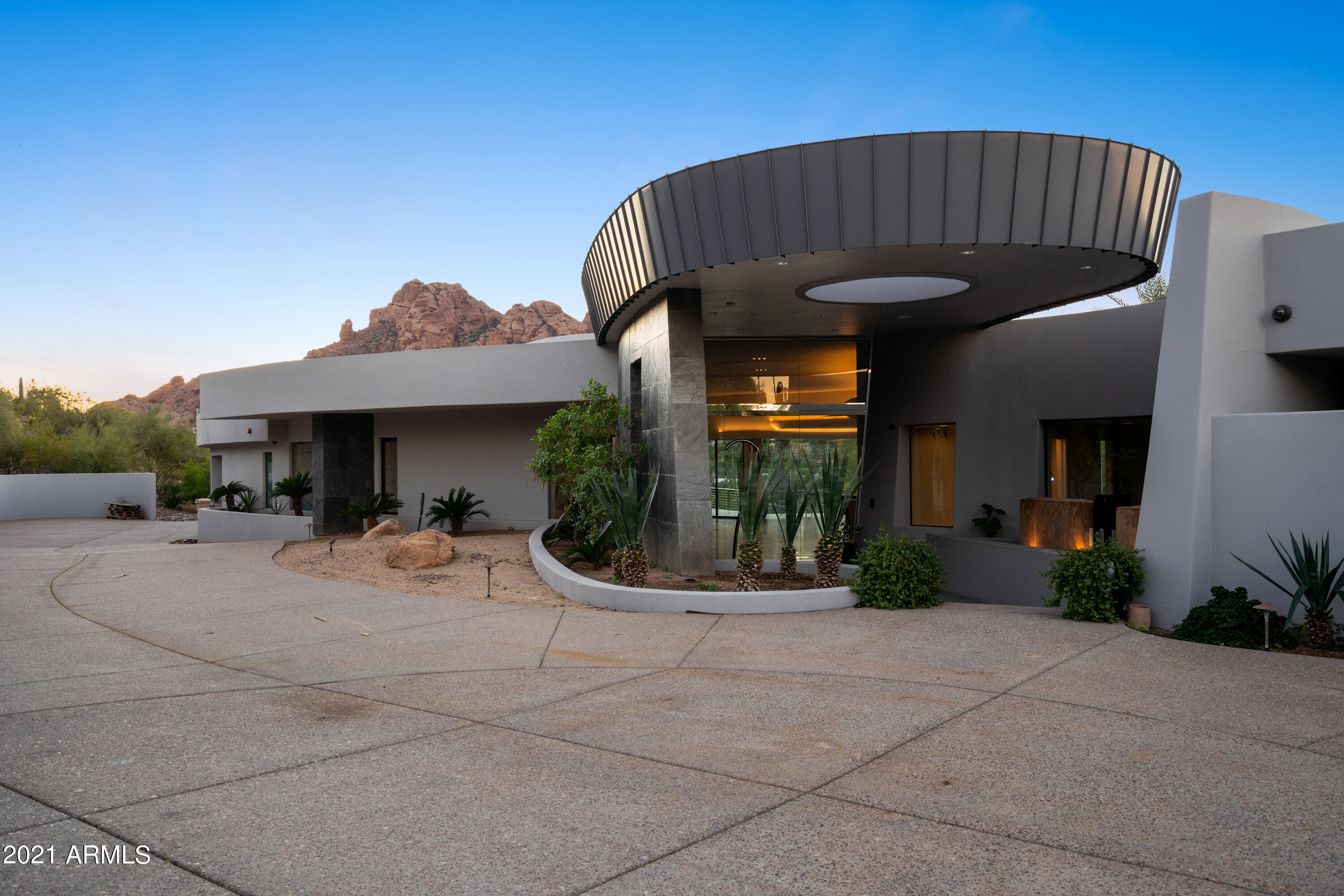 Unobstructed views from everywhere in the house! One of a kind Contemporary Masterpiece designed by Drewitt works Architecture and built by Sonoran West Development. Made for entertaining the View is centerstage from every room, patio and deck. Floor to ceiling windows capture majestic views of Camelback and the city lights. This Masterpiece just received a down to the studs renovation. The new interior has all new flooring a $200,000 kitchen that was just installed including custom cabinets and a new 60'' Wolf range.  There is also a custom temperature-controlled wine room, updated lighting, new fixtures, a theatre room and new Trane A/C units. The home also just got new paint inside and out. Outside you will continue to be amazed by the level of thought that went into creating a true out door living area. Large, curved Patios and decks capture 180-degree views spanning from downtown to Camelback Mountain. The pool has been rebuilt and features a waterfall, slide and spa. The new artificial turf looks so good you will never know it's not real but creates an easy to maintain oasis in the desert. This is truly a special place ready for the new owner to enjoy.