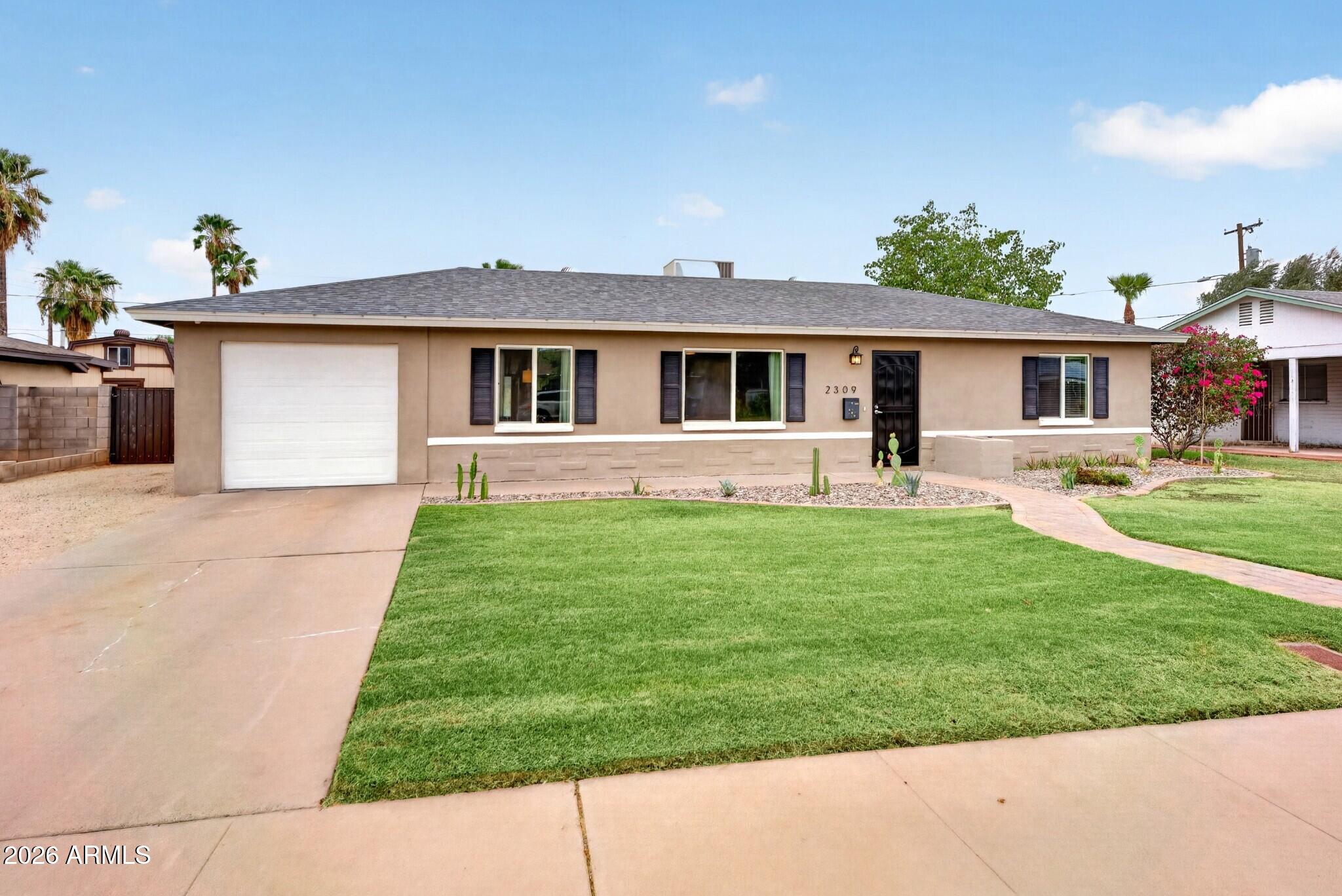 Beautifully updated 3-bedroom, 2-bath home in the desirable Westwood Village neighborhood. The open-concept floor plan features wood-look tile throughout the main living areas, creating a warm and inviting space for everyday living and entertaining. The kitchen is highlighted by quartz countertops, a Carrera marble backsplash, stainless steel appliances, and ample cabinet space. The spacious primary suite includes a custom walk-in shower with timeless subway tile finishes. Step outside to a large backyard with lush grass and a covered patio, offering plenty of room to relax, play, or entertain. Conveniently located near the Melrose District, Downtown Phoenix, shopping, dining, and entertainment, this home combines modern style with an unbeatable central location.