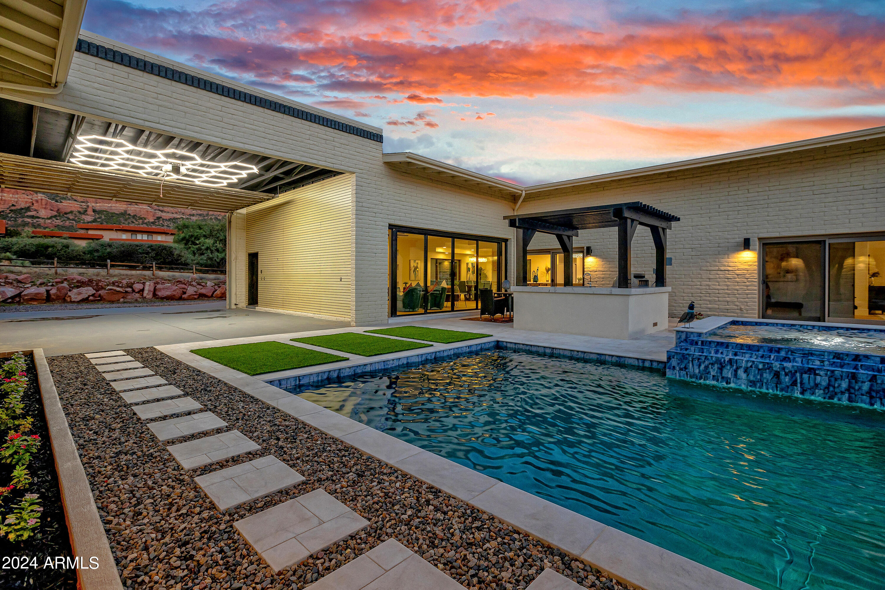 Discover your personal oasis in unincorporated Sedona with this breathtaking 2.09-acre estate & getaway retreat, offering unobstructed views of the iconic Cathedral Rock. This custom-built Craig Stromme masterpiece underwent an extensive 2024 remodel featuring contemporary elegance. Ideal for the private professional or multi-generational living offering 5 bdrms/ 4.5 bths or incredible investment opportunity or solution for car collectors. Just add lifts to the TWO 4 car garages and now you can house 8 Cars. Spectacular Views: Every room in the main home and the expansive courtyard offers awe-inspiring Red Rock views, ensuring a constant connection to nature's beauty. Single-Level Living: Designed for accessibility and ease, featuring a thoughtful layout with spaces adaptable for offices ,home gyms, or yoga studios. Grand Interior: Step into a bright, airy space with 10-ft ceilings, glass sliders, and windows galore. The dining room and kitchen boast coffered ceilings adorned with dazzling chandeliers, creating a stunning visual impact. Chef's Kitchen: An expansive culinary space with white quartz countertops, a massive center island housing smart convection/microwave combo and dual beverage fridges, complemented by top-tier Café Appliances. Luxurious Primary Suite: Includes a lavish bath with an oversized walk-in shower, soaking tub, dual vanities, and an oversized smart mirror. Guest Accommodations: An attached guest casita offers a spacious en-suite bedroom with a separate entrance, a studio/game room/office area with a wet bar, and an adjoining suite with kitchenette/dining combo. Courtyard Oasis: The 2,640 sq ft courtyard is an entertainer's dream, featuring a heated lap pool, therapeutic spa, sunken firepit, and a trellised BBQ station with stainless steel Blaze Grill. Four Car Garage: Two massive 600 sq ft garages with 12 ft ceilings and LED honeycomb lighting, one side open to the courtyard for a shaded relaxation area with stunning Red Rock views. Outdoor Space: Ample room for recreational activities, including potential for an oversized RV garage and space for horses or additional amenities. Prime Location: Close to Red Rock Crossing and Baldwin Trail, with easy access to golf, shops, dining, and galleries.
Additional Features: Custom cabinetry, wide doors throughout, Bosch tankless water heaters, Green Energy RHEEM A/C Gas Pack Units, climate-controlled storage, Sierra Pacific aluminum clad wood low-E windows and doors, professionally sealed roof, and a new 2,000-gallon septic system installed in 2024.
This exceptional property blends luxury, functionality, and natural beauty seamlessly. Welcome Home!
