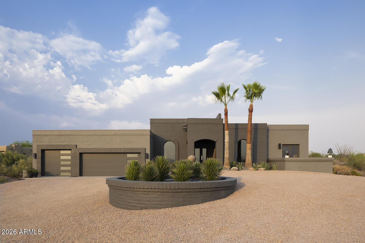 A Home Unlike Any Other. A Work of Art Designed for Living. Welcome to one of Carefree Rolling Hills' most extraordinary residences-where timeless architecture, contemporary design, and breathtaking desert landscapes come together in perfect harmony. Originally crafted with enduring slump block construction, this exceptional home has been thoughtfully reimagined by its current owner into a sophisticated modern retreat. Every detail has been carefully curated to create an environment that is both visually stunning and remarkably livable. At the heart of the home is an impressive 1,000-square-foot great room-a dramatic, light-filled space designed for effortless entertaining and everyday living. Multiple conversation areas, flexible dining arrangements, soaring ceilings, and expansive walls of glass create an atmosphere that is both intimate and grand. The luxurious primary and guest bathrooms have been completely transformed with sleek contemporary finishes, featuring elegant zero-entry walk-in showers that combine beauty with accessibility. Two interior gas fireplaces provide warmth and ambiance throughout the seasons. The oversized three-car garage is a dream for collectors, hobbyists, or car enthusiasts, complete with its own HVAC split system and extensive built-in storage. The expansive site also offers exceptional flexibility, with room to add a detached garage, guest casita, studio, or private retreat to suit your vision. Step outside and experience the magic of the Sonoran Desert. Spectacular sunsets paint the sky each evening as panoramic views stretch across Black Mountain and the Continental Mountains, creating a backdrop that changes by the hour and never grows old. With an annual HOA of just $60, this remarkable property offers the rare combination of architectural distinction, privacy, room to and exceptional value. Located only minutes from the charming shops, galleries, restaurants, and events of downtown Carefree and Cave Creek, you'll also enjoy immediate access to world-class golf, scenic hiking and biking trails, horseback riding, and nearby boating on Lake Pleasant. This is more than a home--it is a statement of design, a sanctuary for entertaining, and a one-of-a-kind desert residence for those seeking something truly exceptional, your search ends here.