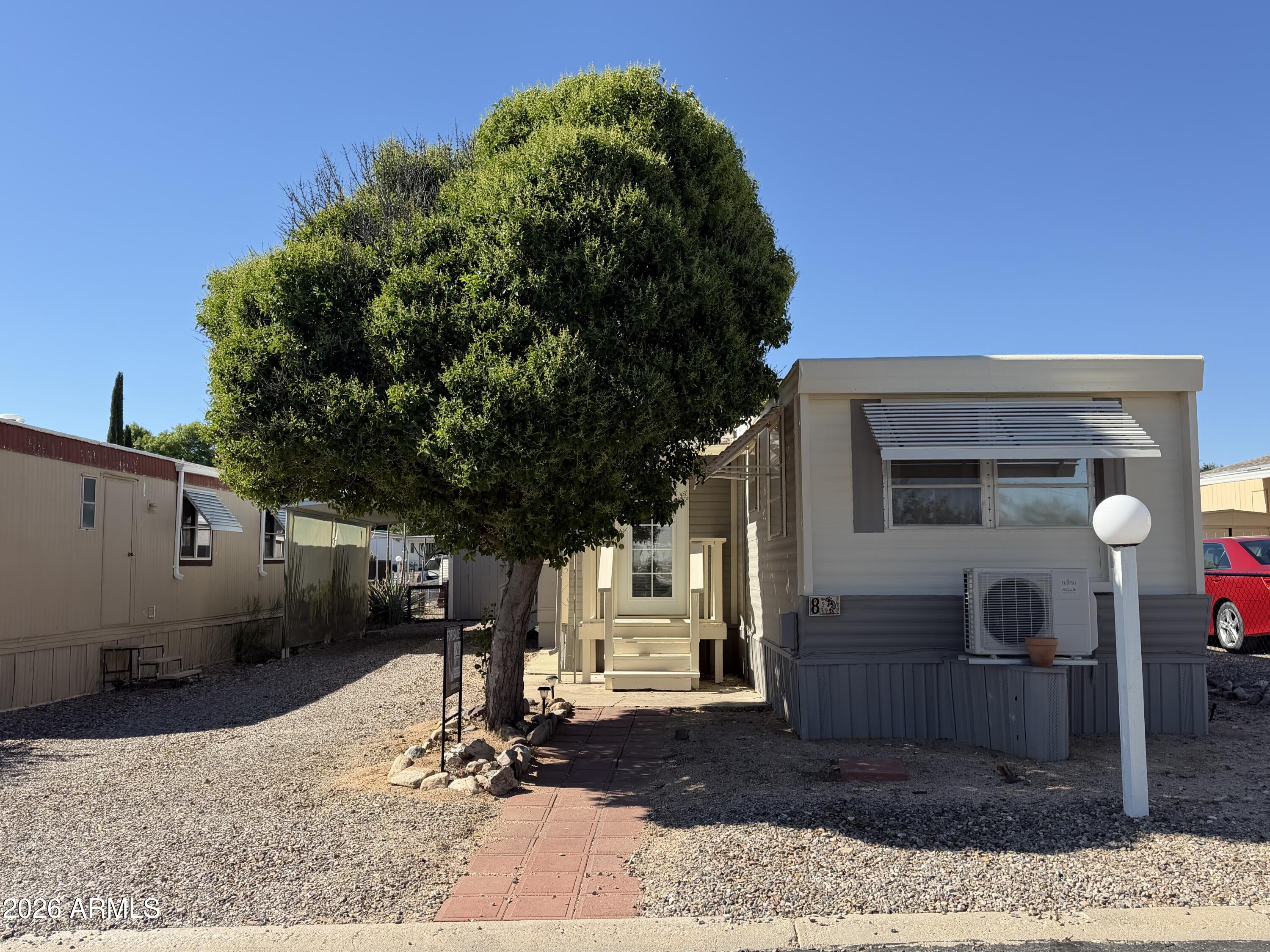 Enjoy affordable Arizona living in the welcoming 55+ community of San Pedro RV Resort! This refreshed and move-in ready 1-bedroom home offers comfort, convenience, and resort-style amenities. Recent updates include freshly painted exterior and living room, repaired exterior steps, and a recently recoated roof. Features include two efficient mini-split heating and cooling units, an enclosed Arizona room, stack washer and dryer, covered carport, and storage shed. Residents enjoy pickleball, bocce ball, shuffleboard, horseshoes, dog park, two clubhouses, indoor and outdoor pools, and an indoor spa. Conveniently located near shopping and dining. Home only; land is leased. Lot rent is $492/month. Buyer subject to park approval.