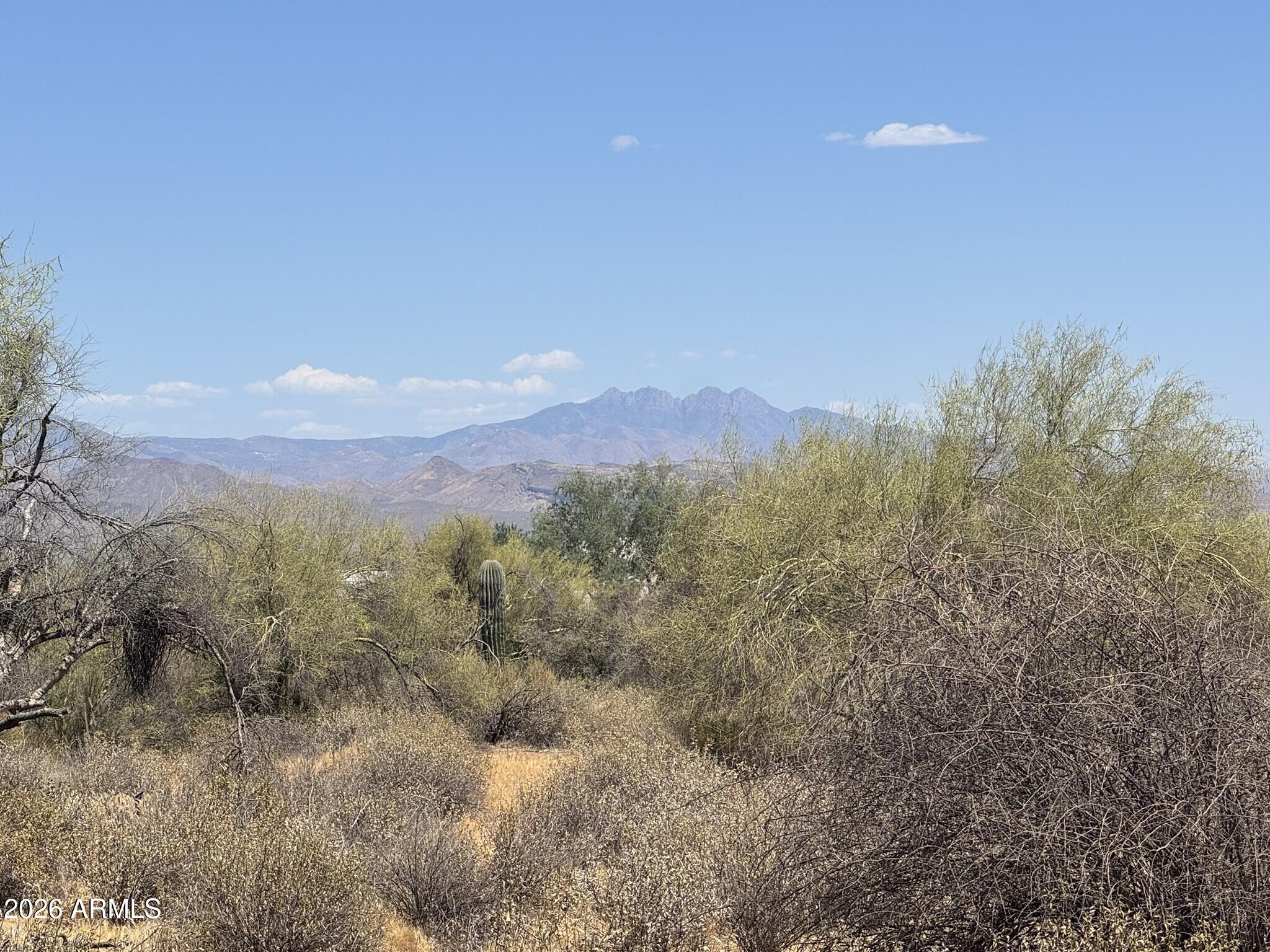 Elevated one-acre lot offering unobstructed views of Four Peaks, Weaver's Needle, the McDowell Mountains, and surrounding mountain ranges. This property features three highly desirable advantages: no floodplain, paved road access, and a shared well serving only three properties. Paved-road lots are a rare find in this area, with custom homes nearby adding to the appeal. Located just minutes from Needle Rock Recreation Area and ideally situated near Tonto National Forest, the Scottsdale Preserve, and nearby golf courses, this lot offers easy access to hiking, biking, off-roading, horseback riding, and endless outdoor adventures. A wonderful opportunity to experience serene Arizona living!
