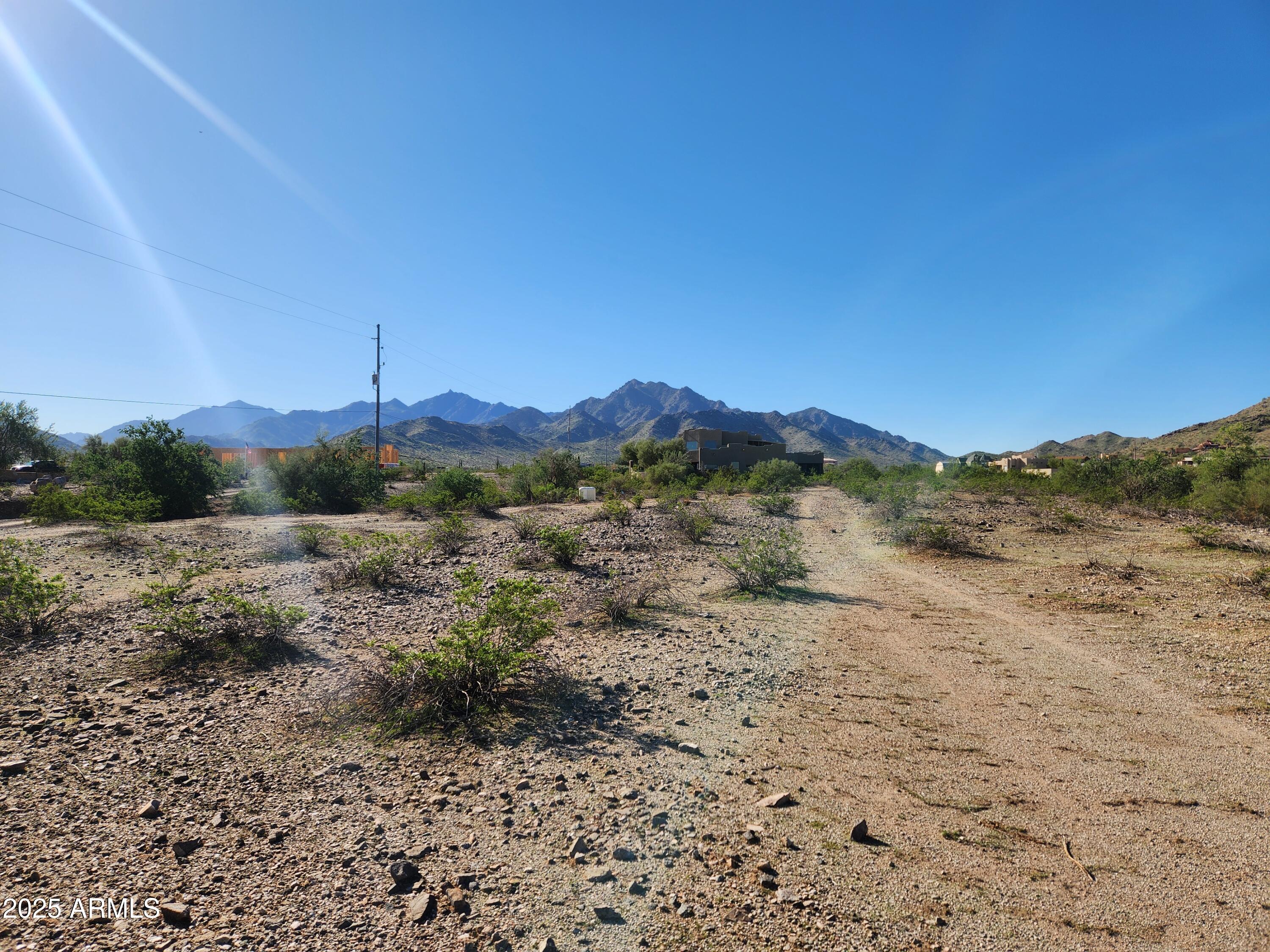 Great opportunity to own this 1.176-acre lot with spectacular views of the Estrella Mountains. This lot is located in a beautiful neighborhood surrounded by custom homes. There is no HOA, and water is provided by a shared water well.