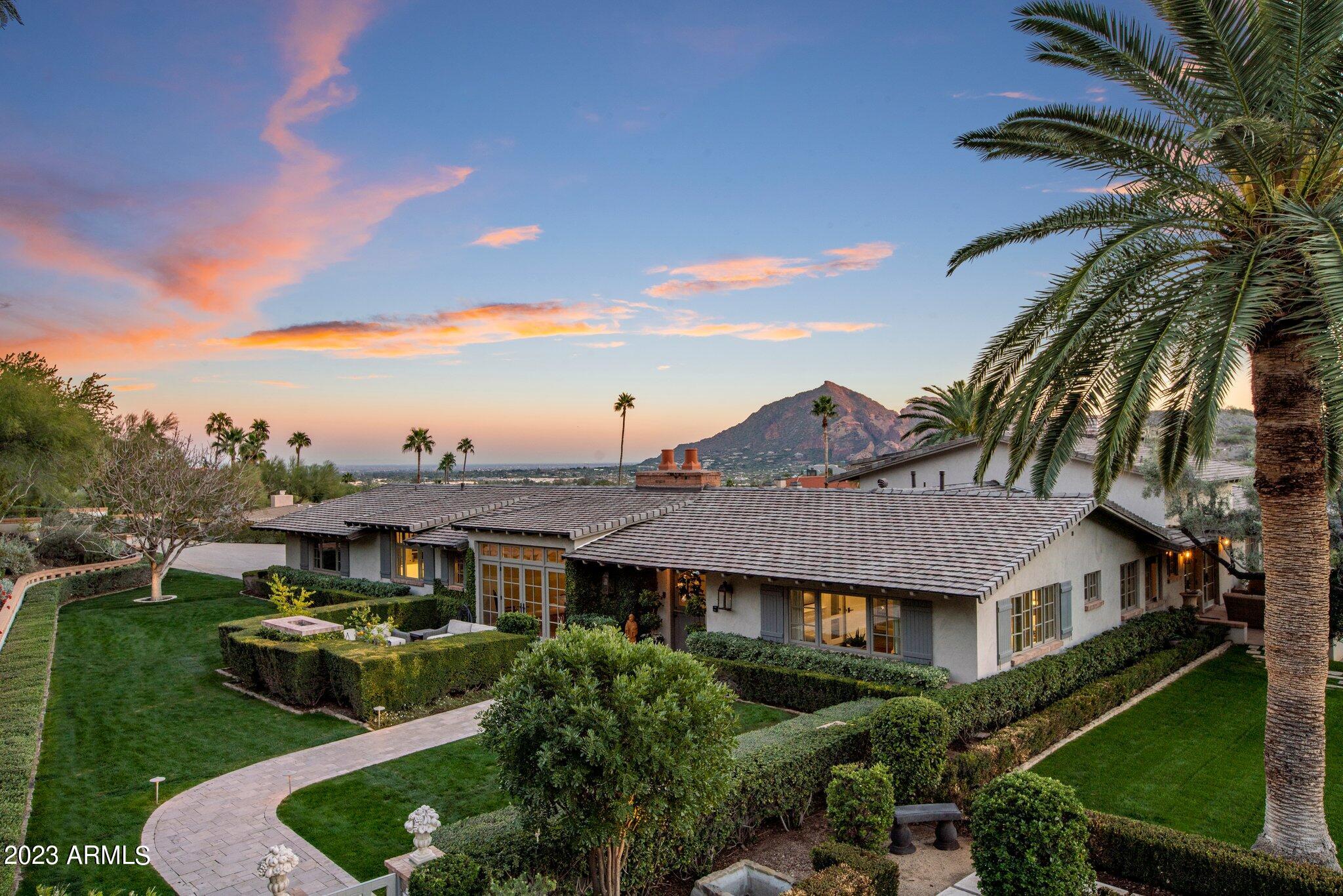 Luxurious Living in PV! From the moment you walk in through the Front Courtyard & you enter thru the Dutch Door, you'll realize you're not in that quintessential home in Paradise Valley, you have entered the Next Level. There are private Patios off all Living Spaces, Dining Rm, Kitchen & 2 bdrms & each offer seating spaces, fireplaces & views that go beyond what the eye can see. The living spaces offer all you could ever need including oversized Fireplaces, Vaulted Ceilings w/an Enormous Iron Chandelier, Custom library Bookshelves, 100 yr old Wood Beams from a Pennsylvania Barn & a one of a kind Bar area (wet) off the entry & sitting area! This PV Estate offers over the top uniqueness from the French Country Chef's Kitchen w/Calcutta Marble Countertops & it's very own Brick Fireplace Commercial Wolf Gas Range w/Double Ovens, Built-In Sub Zero Stainless Refrigerator, Walk in Refrigerator and Fully appointed Butler's Pantry. This home offers 3 Guest Suites w/1 that offers a private entrance to make it a true Guest Quarters with direct access to the back patio. The Primary Suite on the south side of home offers an oversized Custom Fireplace & private s/w facing Balcony. The Primary Bath is something out of a Fairytale... gorgeous Calcutta Marble Countertops, dual Custom Vanities, Makeup Vanity, Custom Closets (2 closets), Steam Shower, it's own Laundry area and so much more! 
This home offers all wood & tile flooring w/no carpet and custom Crown Molding throughout. There are 3 garage spaces and 3 additional parking areas on the property. 
Every single room in this home captures the stunning Mountain Views, expansively manicured grounds & all the serenity this home offers! 
The Resort like yards (front & back) & pool area are like nothing else! You'll find yourself wanting to jump into the 25M Heated lap pool for an afternoon swim while capturing the sunsets over Camelback Mountain. 
The home was completely renovated, from top to bottom, by Mark Candelaria and Andra Miller designs & completed in 2016 with not one detail overlooked and no expense spared. 
The home has a full newer Concrete Tile Roof (2018 w/warranty), 4 new A/C units, a temperature-controlled Garage, New Tankless Gas Water Heater, New On Demand Hot Water Heater, New RO Water Cooler at Wet Bar, New Condenser for Walk In Refrigerator, New Pumps for Swimming Pool, New Irrigation System, 2 new Septic Tank Pumps, new LED Lighting under Cabinetry in Kitchen/Bar/Laundry & Office, New Door on Office Entry and so much more!
Clearwater Hills community has recently resurfaced the roads and added Fiber Optic Internet Lines to each home. Internet is covered through the HOA as well.
THIS is a one-of-a-kind property you will not want to miss!