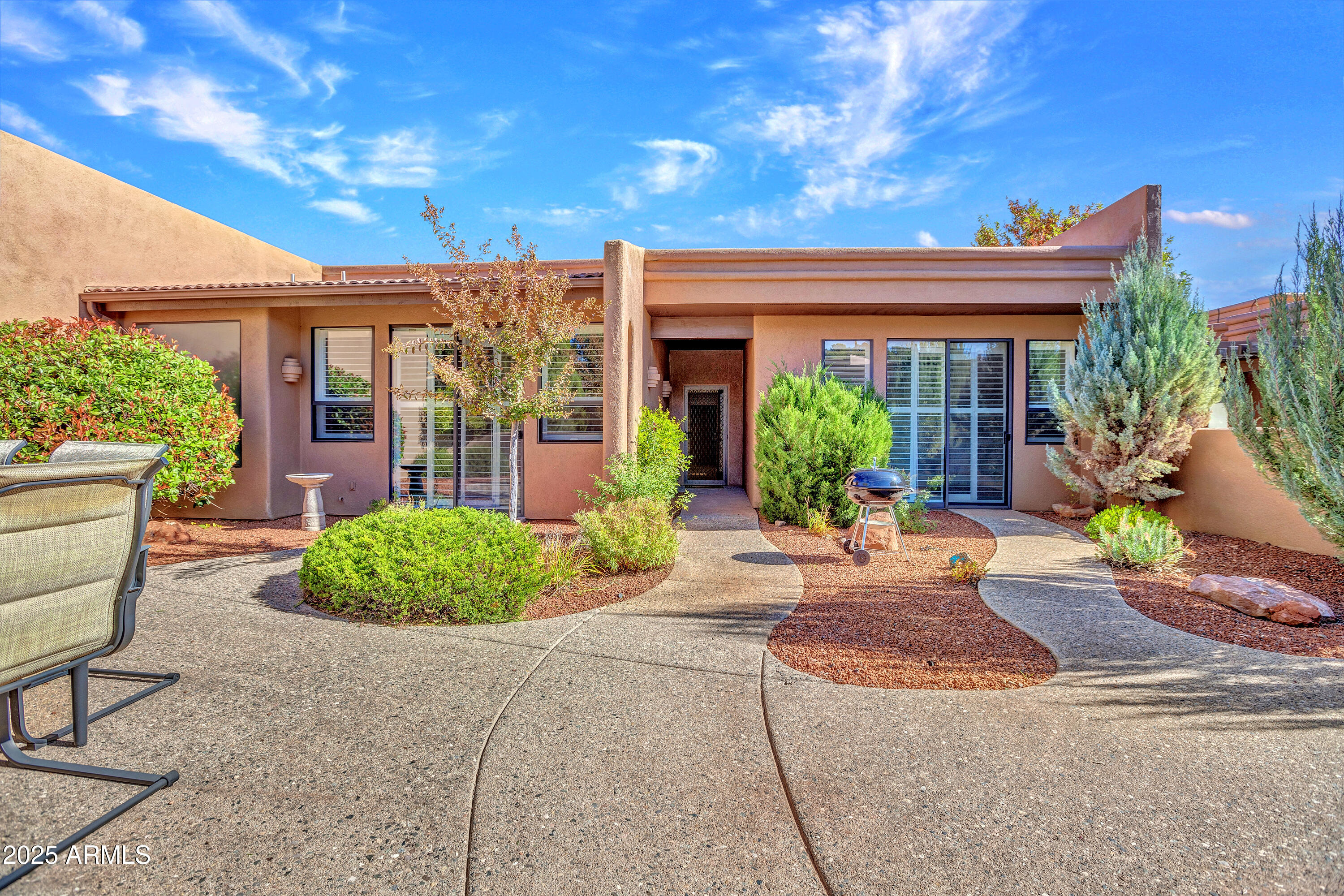 Lock the door. Walk to everything. Repeat.
Now priced at $699K and finally, it feels dialed in. Welcome to Arroyo Seco, where single-level living meets actual ease. No stairs. No dead space. Just under 1,600 sq ft of light, scale, &  a Thunder Mountain backdrop that never gets old. Clerestory windows and walls of glass blur the line between inside and out. The great room lives larger than expected. The Large patio? Built for sunsets, outdoor dining, and low-maintenance living. 
Two bedrooms, two baths, and just enough separation to host or unwind without friction.
Pool and spa two doors down. Trails, coffee, groceries...all walkable. This is Sedona without the complication. Clean. Simple. Done right. Lock-and-leave easy. Harder to forget than you think. Priced to Move. Designed to Stay!