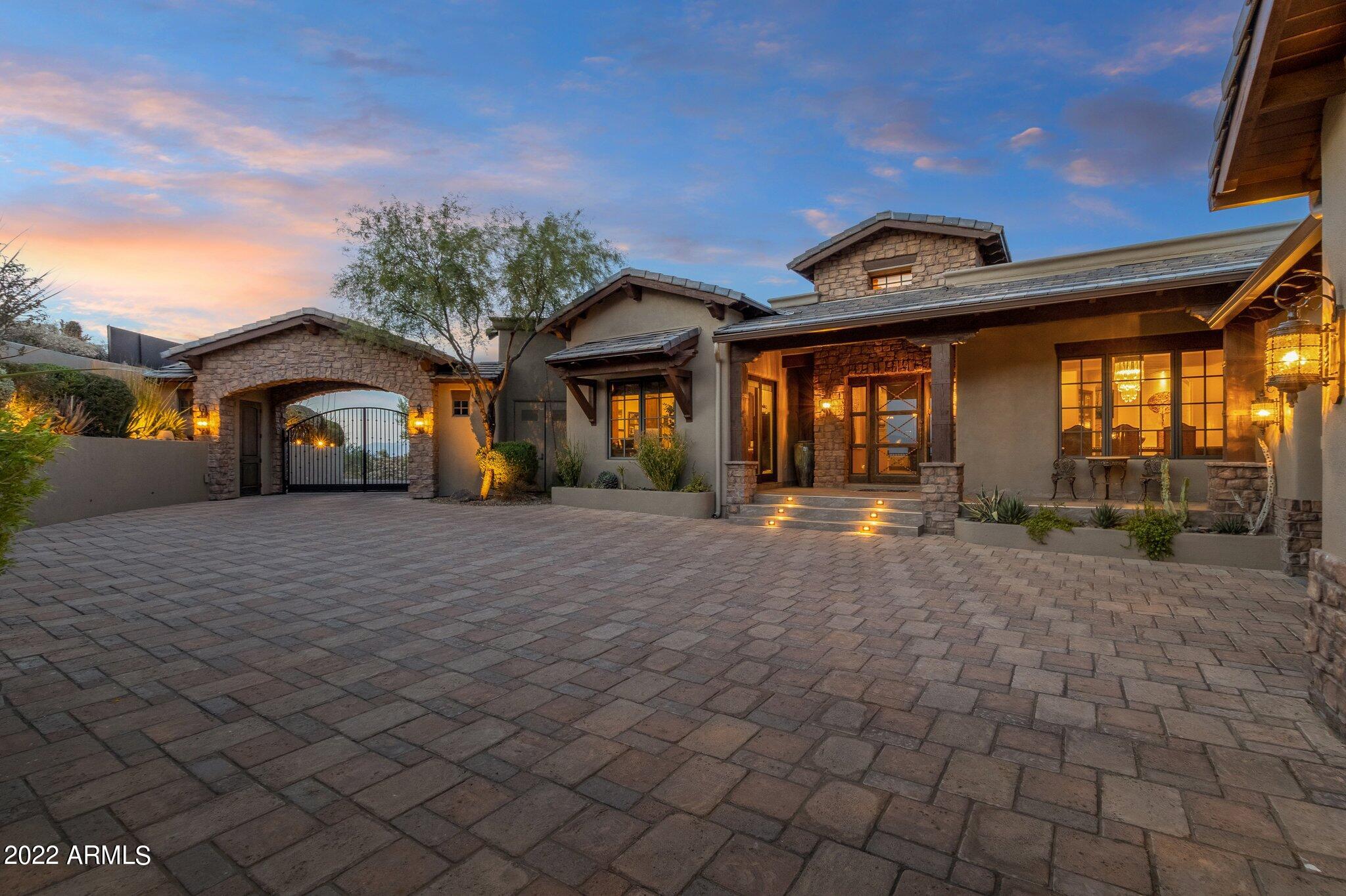 Featuring some of the most breathtaking views in the valley, this smart home was made for entertaining or sitting and enjoying the amazing mountain views. An entertainers dream, hand crafted soaring wooden beams, solid core doors and  24'' travertine tile throughout the home.  Large master with views, steam shower, gigantic bathroom, Spacious great room, chefs kitchen with huge granite island.  Huge game room with open bar, fully retractable glass doors, leading out to the infinity edge pool and spa. Full misting system to enjoy the hot summers, while enjoying the amazing views.  Sit back in the theater and enjoy a movie.  8 balconies, elevator, formal dining and wine cellar are just some of the amazing features in this home. Home comes fully furnished