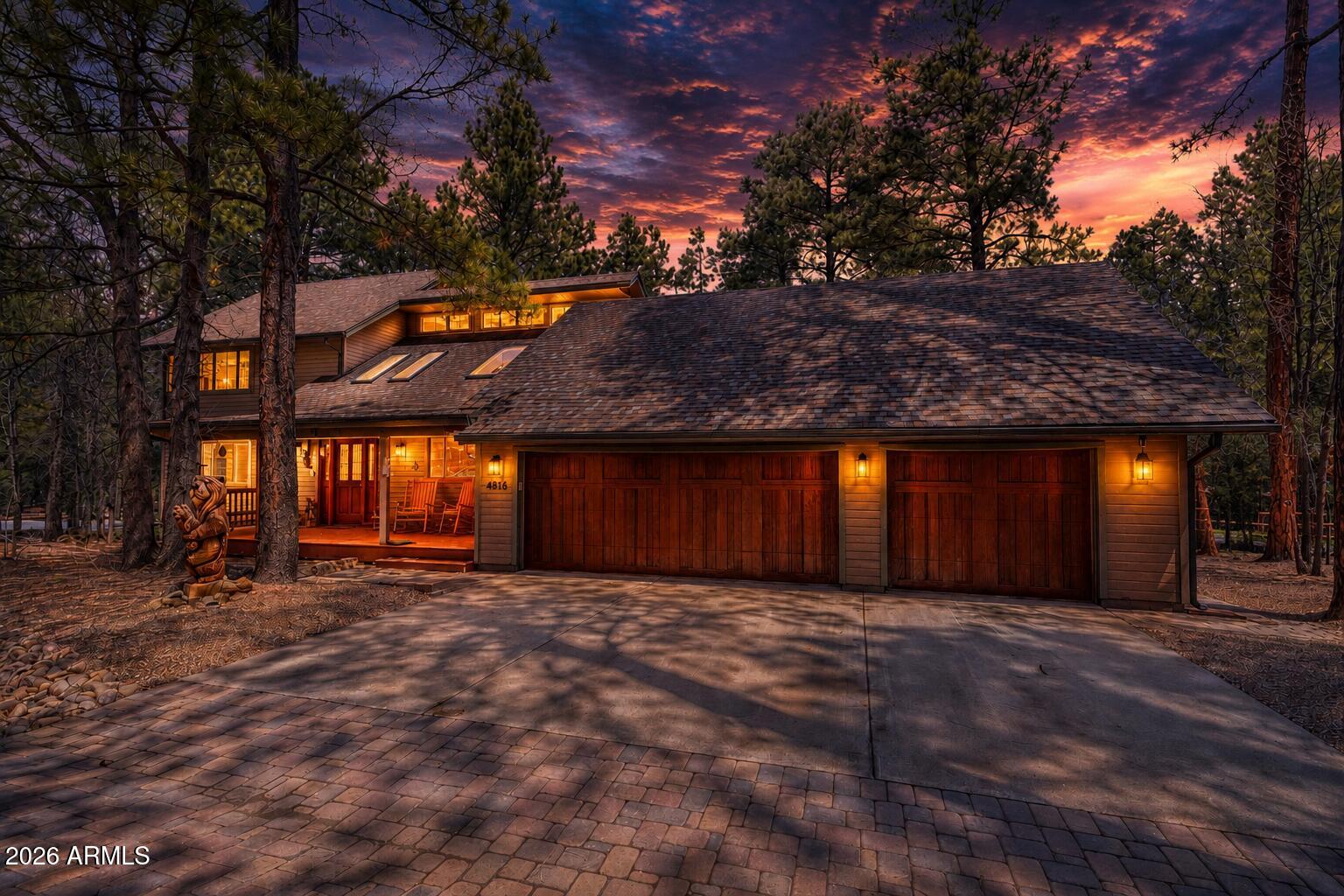 Cabin in the Woods Retreat - Fully Furnished & Move-In Ready! Escape to the beauty of the pines in this stunning, fully furnished cabin situated on a desirable corner lot. Offering the perfect blend of rustic charm and modern comfort, this turnkey mountain retreat is ready for you to enjoy from day one. A paver driveway welcomes you to the temperature-controlled, fully stocked 3-car garage - ideal for protecting your vehicles, boat, golf cart, and outdoor gear. Spend your days exploring nearby lakes, scenic trails, and the natural beauty that surrounds the community. Step inside from the covered front porch to a welcoming foyer that opens into a spacious great room. Soaring ceilings and oversized skylights fill the home with natural light, while the cozy wood-burning stove creates... the perfect mountain-lodge atmosphere. The open-concept kitchen is designed for gathering and entertaining, featuring stainless steel appliances, abundant workspace, and seamless flow into the living and dining areas. Just beyond the great room, an expansive covered patio overlooks the private, tree-filled backyard, creating an ideal setting for outdoor dining, relaxing, and making memories. Gather around the large firepit with family and friends under the stars. The main-level primary suite offers comfort and convenience with a private bath featuring dual vanities, a walk-in shower, and a separate water closet. Upstairs, guests will enjoy spacious bedrooms with walk-in closets and a well-appointed guest bath. Residents also enjoy access to outstanding community amenities, including a clubhouse, fitness room, tennis courts, pool, and spa. Whether you're searching for a personal mountain getaway, a full-time residence, or an income-producing vacation rental, this property checks every box. With accommodations for up to 12 guests, it offers exceptional potential as a VRBO or short-term rental investment. Don't miss this rare opportunity to own your own slice of mountain paradise!