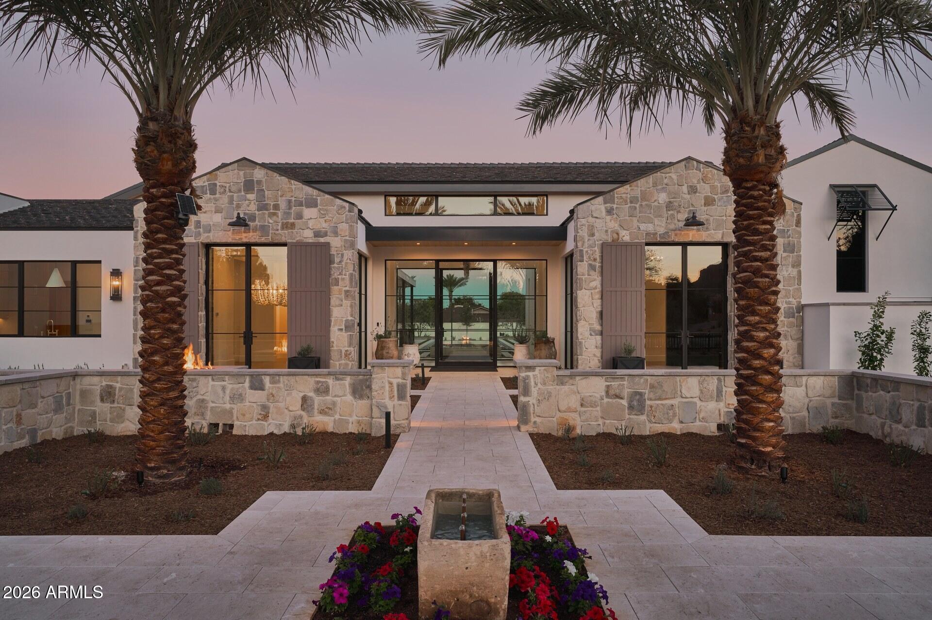 Welcome to one of the most exceptional estates in Paradise Valley. This ultra-luxurious residence showcases unparalleled craftmanship and attention to detail, with no expense spared. The home features 6 bedrooms, 7 full baths, 2 half baths, an office, home gym, theater, game room, and two bars. Designed for entertaining, the estate includes a pickleball court, 742-climate controlled wine wall, outdoor kitchen and bbq, rooftop deck with fire pit, and a heated negative-edge glass-tiled pool with in water bar seating. Four climate controlled garage bays with high ceilings to accommodate car lifts. A luxurious two bedroom guest house with a private patio offers comfort and privacy. Privately gated and set within Finisterre, Paradise Valleys premier 24/7 man-gated enclave. The estate delivers exceptional security, privacy, and sweeping views of Camelback Mountain. Interiors impress with custom lighting, millwork, wall treatments, and a chefs kitchen outfitted with top tier appliances. The resort inspired primary suite features dual walk in triple hung closets, a steam shower, makeup vanity, and private patio with fireplace. Rarely do location and architectural excellence align so perfectly. This remarkable offering at 61st Place reflects 25 years of dedication to perfection by J.M. Wall Development.