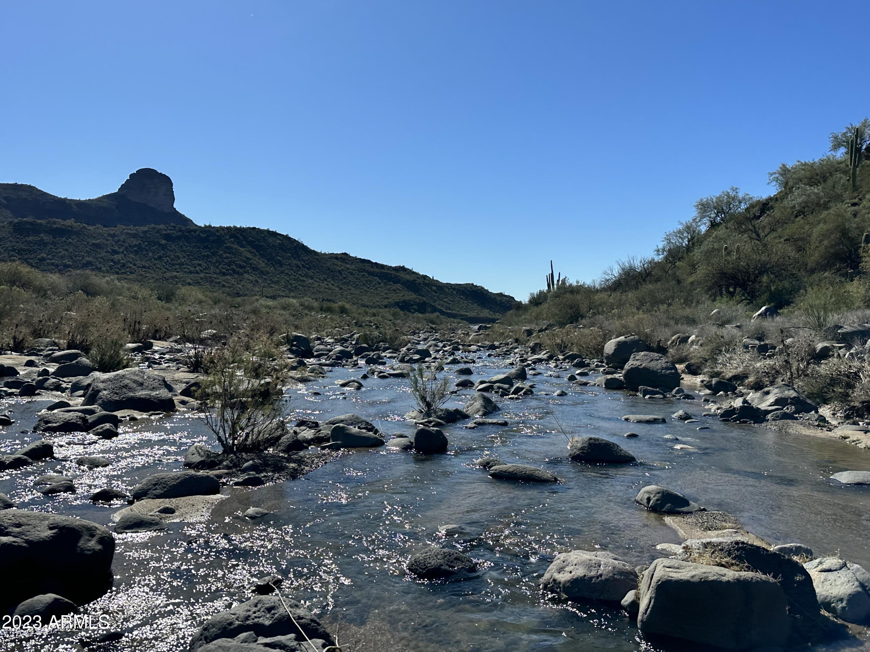 Working cattle ranch, 18,095.62 acres BLM grazing permit 250hd year round. 97 deeded acres with the Aqua Fria River crossing the deeded acres. 4 houses: main house 8112sqft 5bdrm, 6baths, pool, 1bdrm, 2 bath apartment, 2nd home is 3841sqft 4bdrm, 4bath, pool 3rd home is 2038 3bdrm 2bath home, 4th home is 1088 2bdrm, 1bath. Small apartment over the shop, numerous barns, corrals, hay storage, shop, equipment barn, 20 stall mare motel, 6 covered pens, round corral, covered shop area, 4 private wells, Pipe fencing, pastures, multiple storage buildings, old time saloon, irrigation rights, petroglyphs, quiet and secluded but close to Anthem, Phoenix or Prescott. Endless possibilities for this investment opportunity. Private ranch, retreat, treatment center, lodge, vacation destination, etc.
