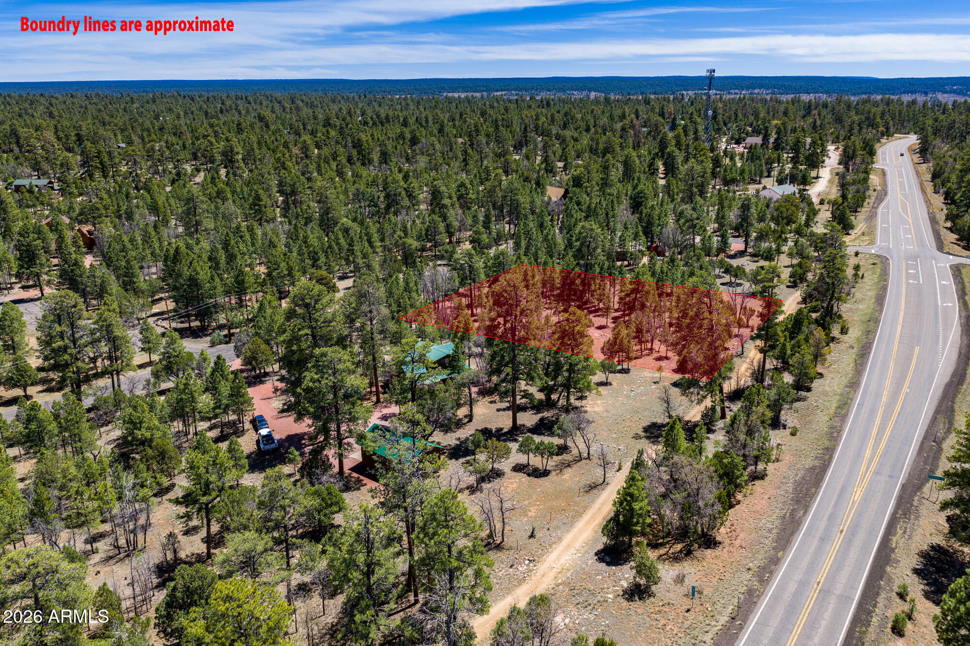 Rare opportunity in the heart of Happy Jack/Blue Ridge! This exceptional 1.31-acre level building lot offers everything you need to bring
your mountain retreat to life, nestled among towering ponderosa pines in one of Arizona's most sought-after high-country communities. The flat, buildable
terrain is ready for construction with power and water readily available at the property, saving you significant time and money on site development costs that
often plague raw land purchases in remote areas. Enjoy true year-round access via well-maintained paved roads right to the lot, with no seasonal closures,
no rough dirt tracks, and no worries about getting in or out regardless of weather conditions, a major advantage in Arizona's high country. Mature ponderosa
pines blanket the property, prov natural privacy, cooling summer shade, and that unmistakable pine-country ambiance that draws so many to the Mogollon Rim region. The established surrounding neighborhood features quality cabins and well-kept homes, creating a welcoming mountain community feel while still preserving the peaceful, wooded atmosphere that makes this area so special. As an exceptional added bonus, the charming home directly next door is also available for purchase and can be acquired together with this lot. Combined, both properties total a generous 2.56 acres, offering a rare chance to create a private family compound, guest retreat, or multi-generational property where combined offerings like this are increasingly hard to come by. Located minutes from world-class outdoor recreation including fishing at Blue Ridge Reservoir, hiking, hunting, ATV trails, and the cool pine-scented air of 7,000-foot elevation, this is Arizona mountain living at its finest. Whether you envision a weekend getaway, full-time residence, or long-term investment, this property delivers.