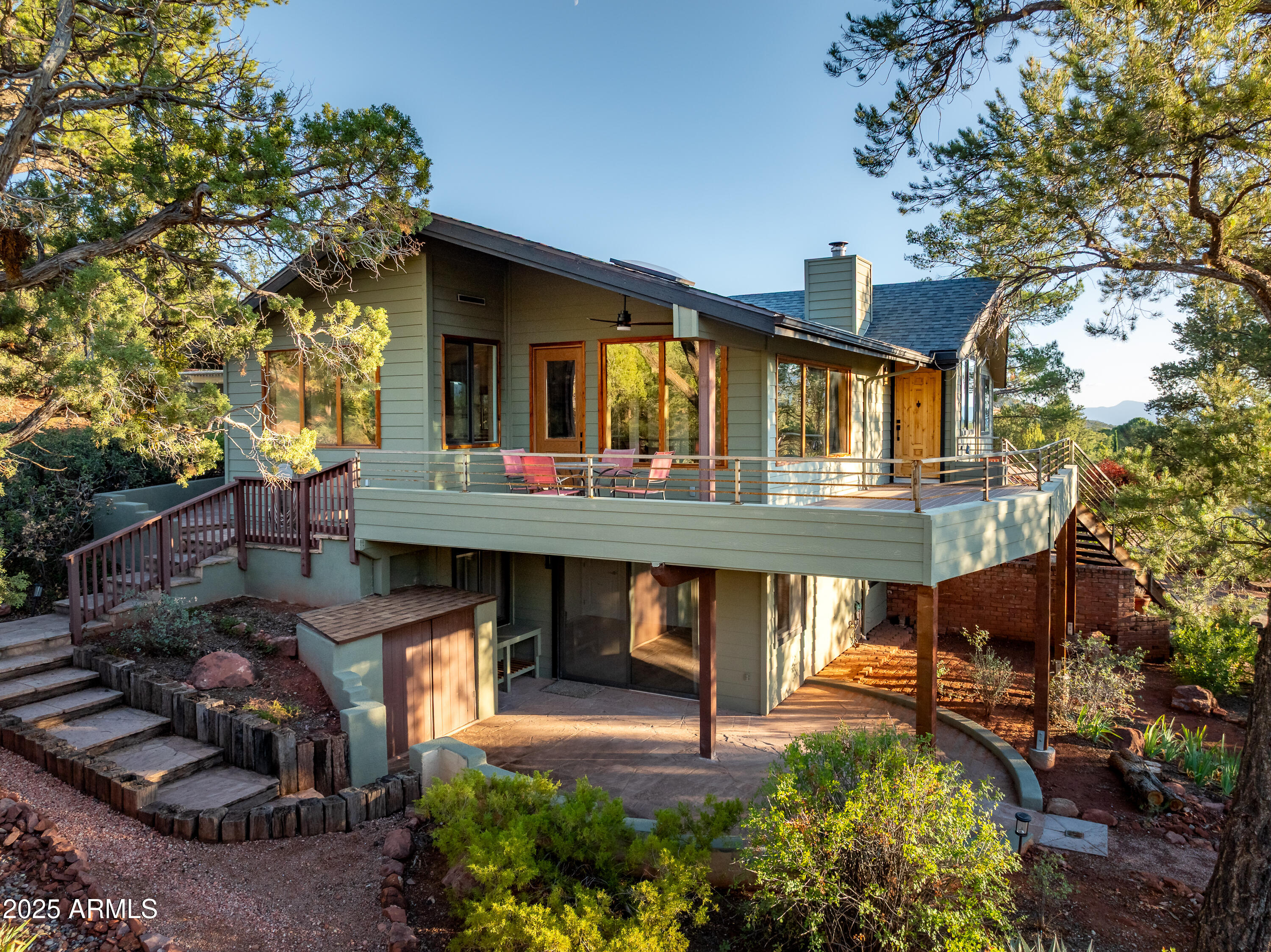 Stunning Sedona red rock views from this newly remodeled Mountain Modern home featuring Bell Rock, Courthouse Butte, Castle Rock, and Lee Mountain! Nestled into a serene, park-like setting and surrounded by towering trees, this beautifully renovated Sedona retreat has a treehouse appeal with modern conveniences. - perfect for full time residence or investment home. This two-story home features high, beamed ceilings in the open and airy living, dining and kitchen areas with expansive windows designed to showcase the nature outdoors and red rock vistas. Doors open onto a view deck for outdoor dining in Sedona's four mild seasons. The oversized primary suite and additional bedrooms provide space for a home office/yoga space or home gym. On the first floor, a bedroom with bath and kitchenette; it's separate entrance and private view patio are ideal for multi-generational living or hosting guests in style. New are a separate wine room and a laundry room. The large two-car garage also offers a workshop area, plus additional storage and utility room.

Enjoy multiple outdoor living spaces - patios and decks, both expansive and open, or private and secluded - that welcome you to relax, entertain, and savor the breathtaking red rock views,
scenery, and adjacent water features. Thoughtfully updated with fine finishes throughout, this residence combines modern comfort and contemporary style with the magic of its natural surroundings.

Don't miss your chance to experience Sedona living at its finest, with this rare opportunity to own an inviting home in one of Arizona's most iconic landscapes. The Village of Oak Creek offers resort style living with hiking, biking, dining, shopping, art galleries, and 3 golf courses. Make 1050 Lee Mountain Road your home: experience the enchantment and beauty of Sedona from a serene setting that celebrates its pleasures, both indoors and out.

Owner to provide a one year home warranty.

What's special...
Breathtaking red rock views
In-law unit for guests
Multiple private outdoor spaces, all with wonderful views
Modern comfort
Electric fireplaces
New kitchen cabinets and vanities
New flooring, windows and doors
Exterior and interior paint
Spacious garage with workshop & storage
