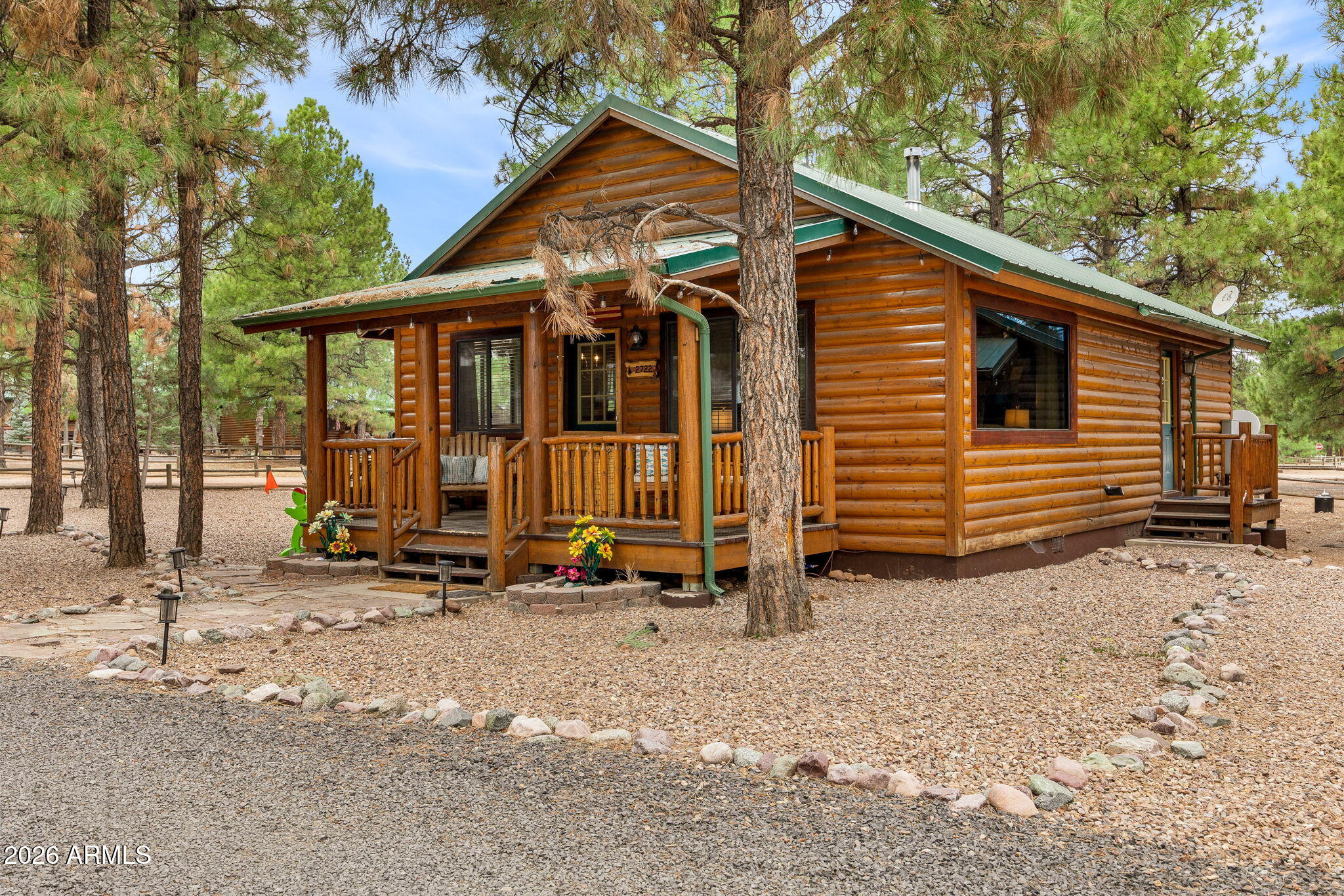 Welcome to your fully furnished mountain retreat! Perfectly nestled among the towering pines on a desirable corner lot in Overgaard's sought-after Bison Ranch community. This beautifully crafted cabin offers two bedrooms, two bathrooms, and an inviting Great Room designed for comfort and gathering. Rich architectural details shine throughout, including wood-paneled vaulted ceilings, warm Hickory hardwood flooring, a striking stone-veneered fireplace accent wall and quality finishes at every turn. The open-concept kitchen is both stylish and functional, featuring custom countertops, sleek stainless steel appliances and abundant cabinetry. The spacious primary suite offers private access to the outdoors and a luxurious en suite bath complete with a copper vessel sink and a custom-tiled walk-in shower with a seamless glass enclosure. Step outside to your landscaped backyard oasis, where a cozy fire pit invites evenings under the stars. Located in the heart of Overgaard, a peaceful four-season mountain destination surrounded by the Sitgreaves National Forest, you'll enjoy cool pine breezes, excellent fishing, scenic hiking and biking trails, and a relaxing escape that's just a 30 minute drive from Show Low, 45 minutes to Pinetop-Lakeside and approximately 2.5 hours from Phoenix.