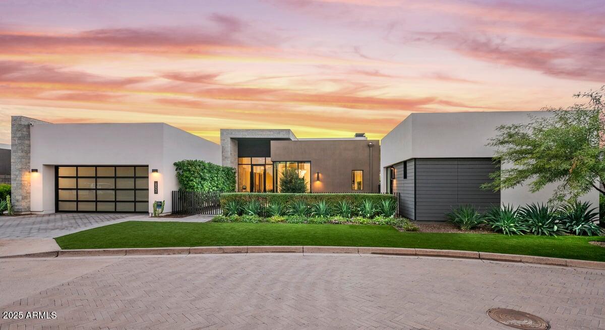 Stunning modern home in gated Azure, Paradise Valley. Ideally positioned on a premium homesite with lovely views of Camelback and Mummy Mountains. Designed for entertaining and comfort, this residence offers seamless indoor-outdoor living with a spacious yard, a covered patio with remote shade and patio heaters, two beautiful casitas, a pergola, putting green, and open play space. Inside, a modern gourmet kitchen features Gaggenau and Thermadore appliances, custom cabinetry, a prep area and a breakfast nook. Additional features include an elevator, custom closets throughout, advanced smart-home technology system that controls music, blinds, and security. Water purification system installed. This property is a true blend of luxury, comfort, & location within one of PV's special communities