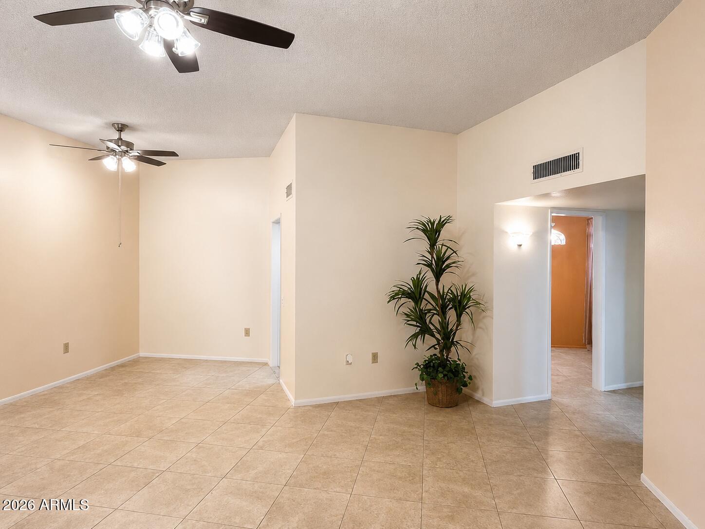 Charming and beautifully maintained condo in the heart of Sun City. This low-maintenance home offers one of the best opportunities in the community, featuring a versatile secondary bedroom ideal for an office, guest room, or hobby space. Lovingly cared for by the same owner since 2001, the home shows true pride of ownership. Updates include a replaced roof, an updated bathroom, and ceiling fans with lighting in the family room with 10-foot ceilings. Step outside to a truly special patio with a custom mural and artistic details that create a relaxing, seaside-inspired retreat. New roof in 2022. HVAC about 7 years old. H2O heater 2022. Enjoy Sun City's renowned 55+ lifestyle with golf, recreation centers, clubs, and amenities nearby. Perfect as a full-time residence or a home away from home