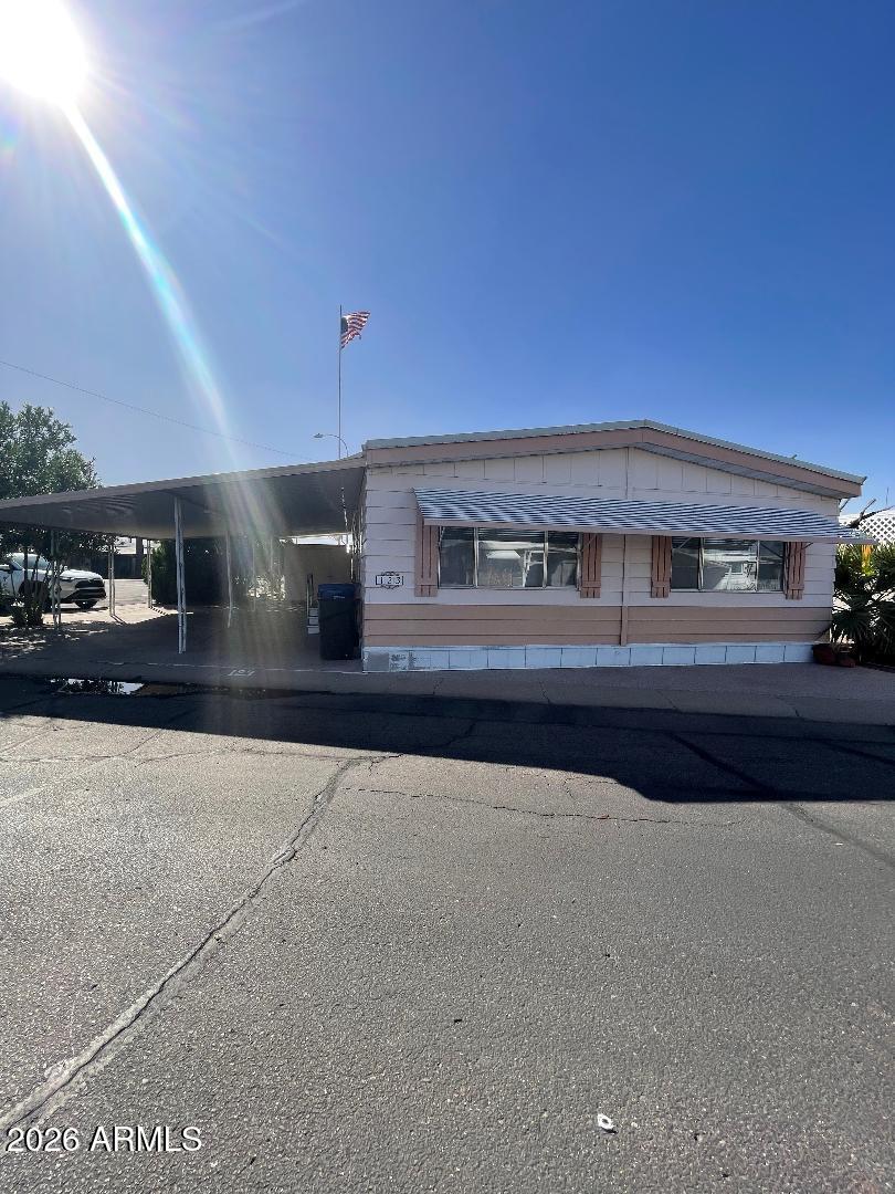 A rare doublewide home in the desirable 55+ community of Deserama Mobile Ranch Park. Located a few steps across the street from the community pool and center! Drive into your covered carport with shade bushes on the side for privacy and an epoxy covered floor. This well maintained home has brand new carpet with LVP flooring in kitchen and bathrooms, new paint, plus it includes the washer/dryer/refridgerator and all window coverings making it move in ready! This home has an abundance of storage areas and closets including a beautiful built in hutch in the dining area. Enjoy the outdoors on a large covered front patio next to the 1 car carport and an 8x8 storage shed that is easily accessible from the patio.