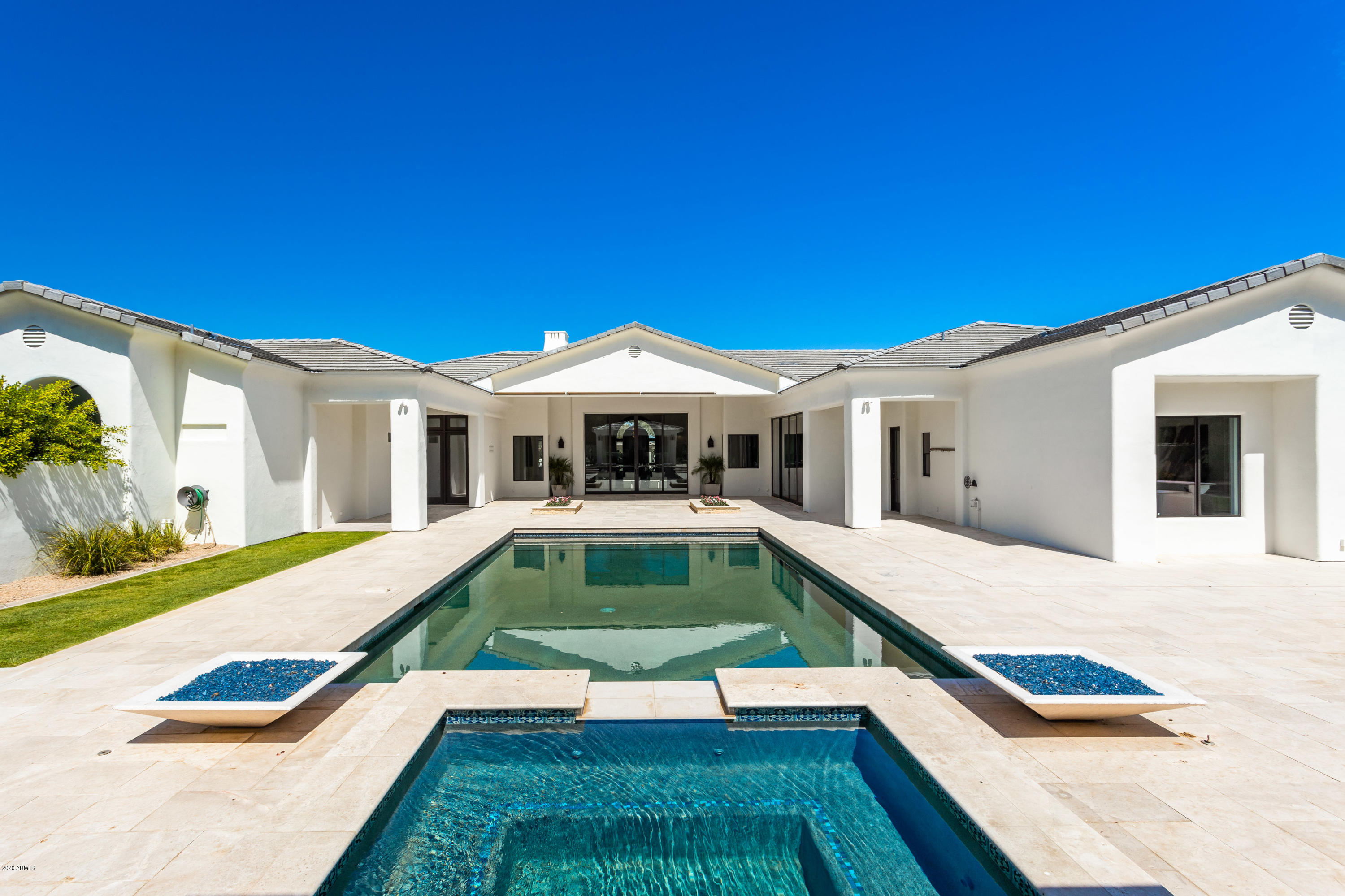 Welcome to this stunning Contemporary estate! Remodeled from head to toe with the finest and timeless finishes and perfectly framed dramatic views of Camelback Mountain! Located on one of the prettiest streets in Paradise Valley, this elegant home offers an amazing floor plan where all of the sizeable rooms provide intimate, cozy living with the capacity for great entertaining. The chef's kitchen boasts sophistication with marble countertops, premium appliances, a solid walnut inset breakfast bar, and hand fired Pratton Larson tiles. The oversized master suite offers a sitting room complete with fireplace and a luxurious spa bathroom with floor to ceiling custom tile work. Featuring 5 ensuite bedrooms, a private office, and a California resort style lush backyard. complete with a gorgeous pool, spa and ramada, as well as many charming outdoor gathering spaces. This home offers something for everyone! Owner is currently still making amazing updates on the home!