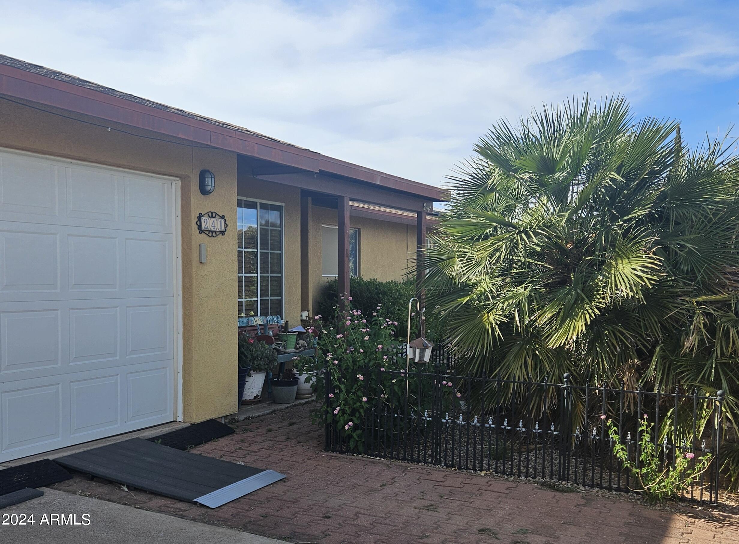 Great mother in law set up. Feels like a Desert Oasis. Mother in law suite. Formal living room, family room with pellet stove, formal dining room, extra large kitchen with beautiful cabinetry, large laundry room with outside access has utility sink and abundant storage, breakfast area with a bay window, 4 bedroom, 3 bath., 2 of the bedrooms and one bath being used as a mother in law area with separate entrance and parking. Has large sink and refrigerator. 2 car garage. Additional air conditioned building being used as a studio/exercise room.  The pool area and backyard feels like your own private paradise. Multiple fruit trees and plants but structured to be easy care.  This is a lot of house for the money!