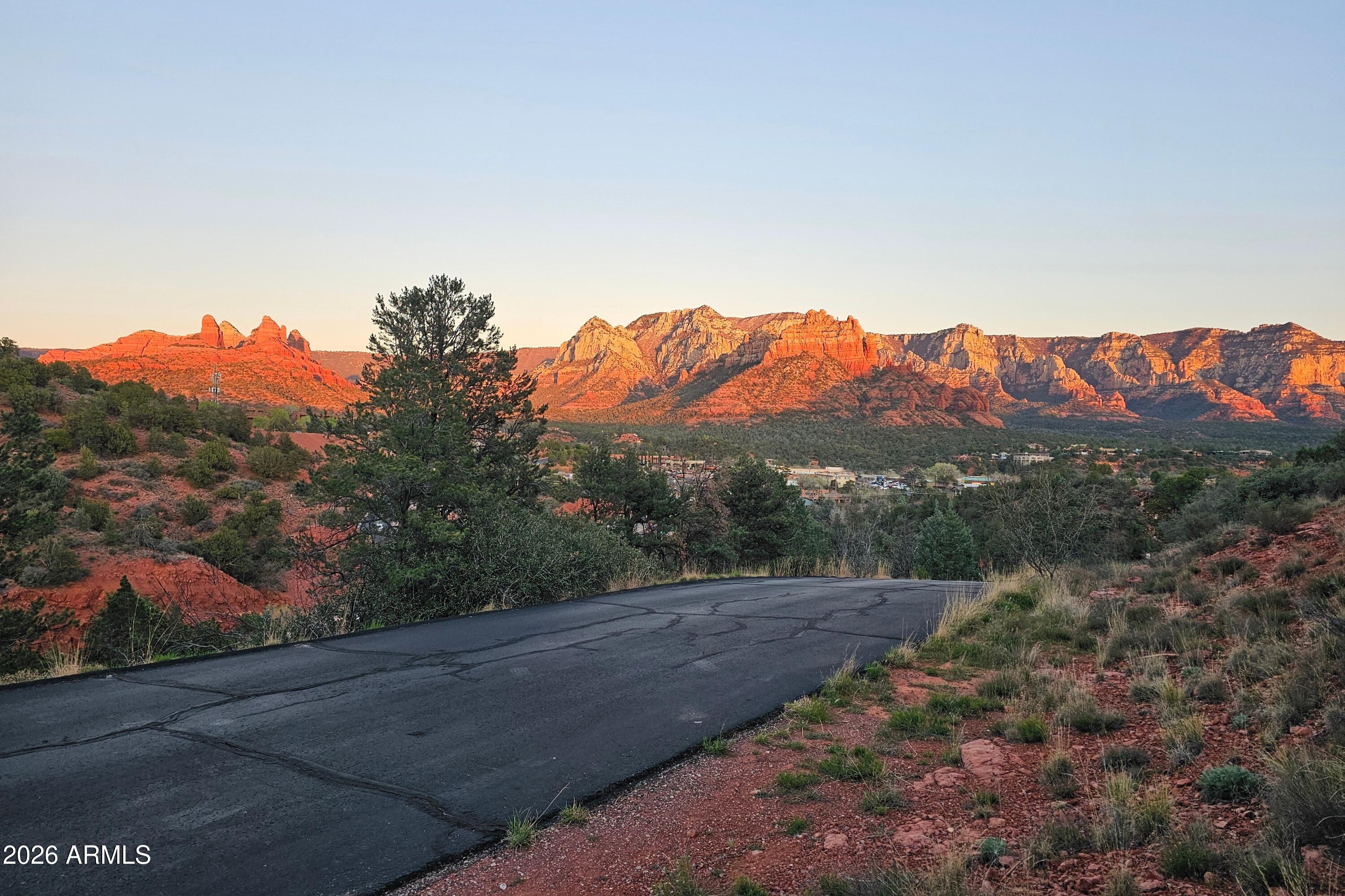 This elevated lot in West Sedona's coveted Rolling Hills Estates is your blank canvas for a custom home with epic views most buyers spend years chasing and never find. The North-facing homesite captures both sunrise and sunset as they paint the red rocks, with unblockable, panoramic vistas in every direction.

To the east, enjoy iconic views of Snoopy and Cleopatra (Camel). Look north to Wilson, Shiprock, and Steamboat. To the west, soak in Thunder Mountain, Coffee Pot, Sugarloaf, and Chimney Rock. Very few lots in town offer this kind of sweeping, 180-degree red rock panorama.

Located in desirable West Sedona, Rolling Hills Estates offers an established neighborhood location with ultra-convenient access to everything: just minutes to SR 179, a straight shot up the canyon to Flagstaff, and close to all West Sedona amenities. Dining, shopping, galleries, and everyday services are all nearby, with multiple world-class hiking and biking trailheads within easy reach.

Rolling Hills Estates is a relaxed, established neighborhood in the heart of West Sedona with low HOA dues of just $300/year. You get pride-of-ownership surroundings without the heavy-handed rules or big fees.

If you're tired of compromising on floorplans, windows, or orientation - 256 Barcelona is your solution! Design exactly what you want and frame every room around jaw-dropping views. This building site offers easy access to everything, and the freedom to build the home you can't find on the market! Note: Seller is an Arizona Licensed Realtor.