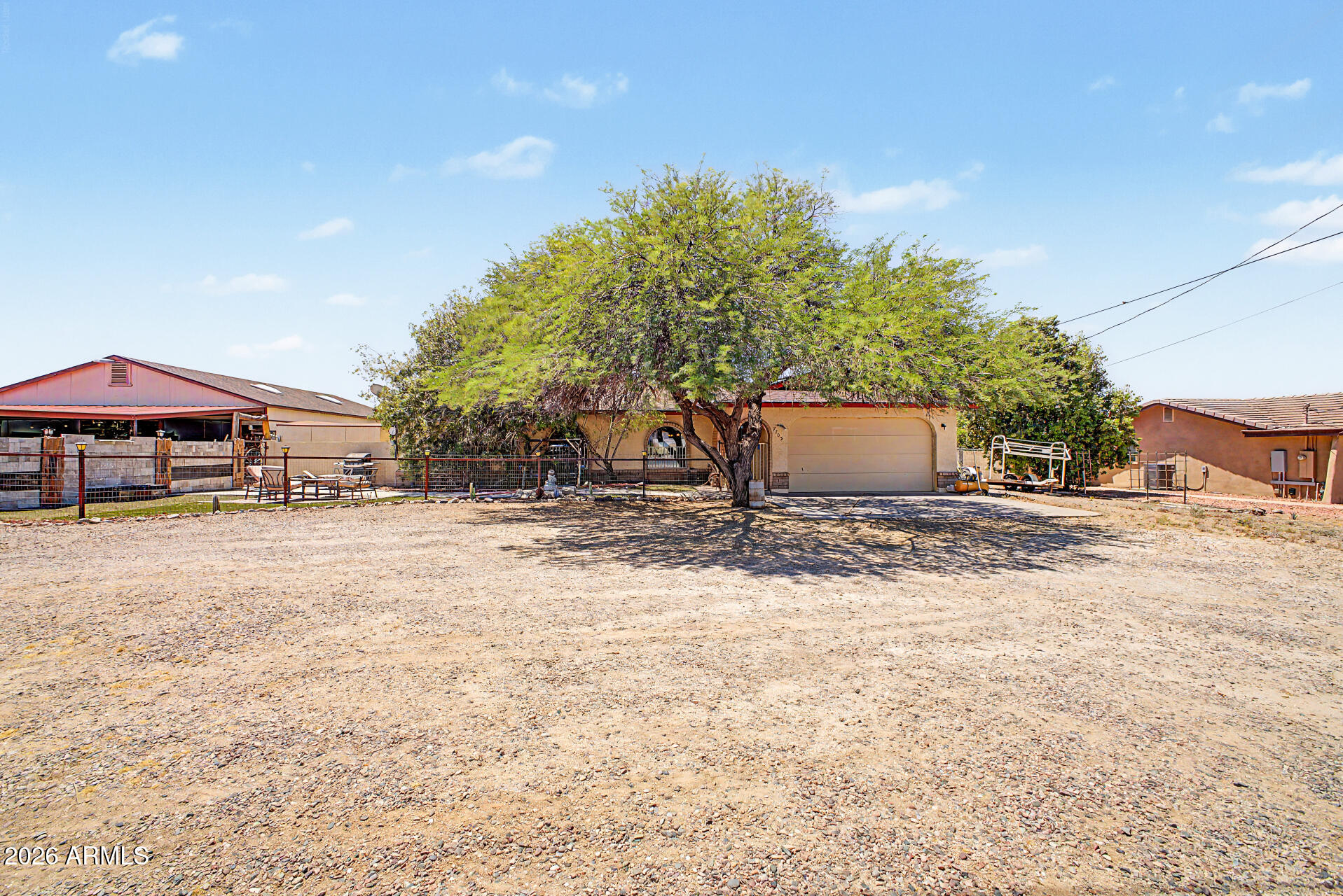 Don't miss this one! 1/2 acre lot with a 36x50 detached shop! This fantastic single-story home offers the perfect blend of space, unique charm, and comfort, featuring sizable living areas with wood-look flooring with a taste of tile, vaulted ceilings promoting a feeling of openness, elegantly tiled walls, wood-look paneling & stone accents that add character throughout, dramatic light fixtures, abundant natural light, and a rich earthy palette that creates a warm and welcoming ambiance. The dining room boasts a fireplace perfect for winter evenings, while the kitchen features spacious cabinetry, granite countertops, and built-in appliances for a seamless cooking experience. The main suite is a true retreat, offering a bathroom and a walk-in closet with attached organizers for added convenience. Out back, you'll have a cozy covered patio ideal for morning coffee, with a serene landscape of artificial grass. Huge 36x50 detached building/workshop waiting for your projects, providing tons of storage, plus a large carport parking space for all your toys. Hurry up and check it out!