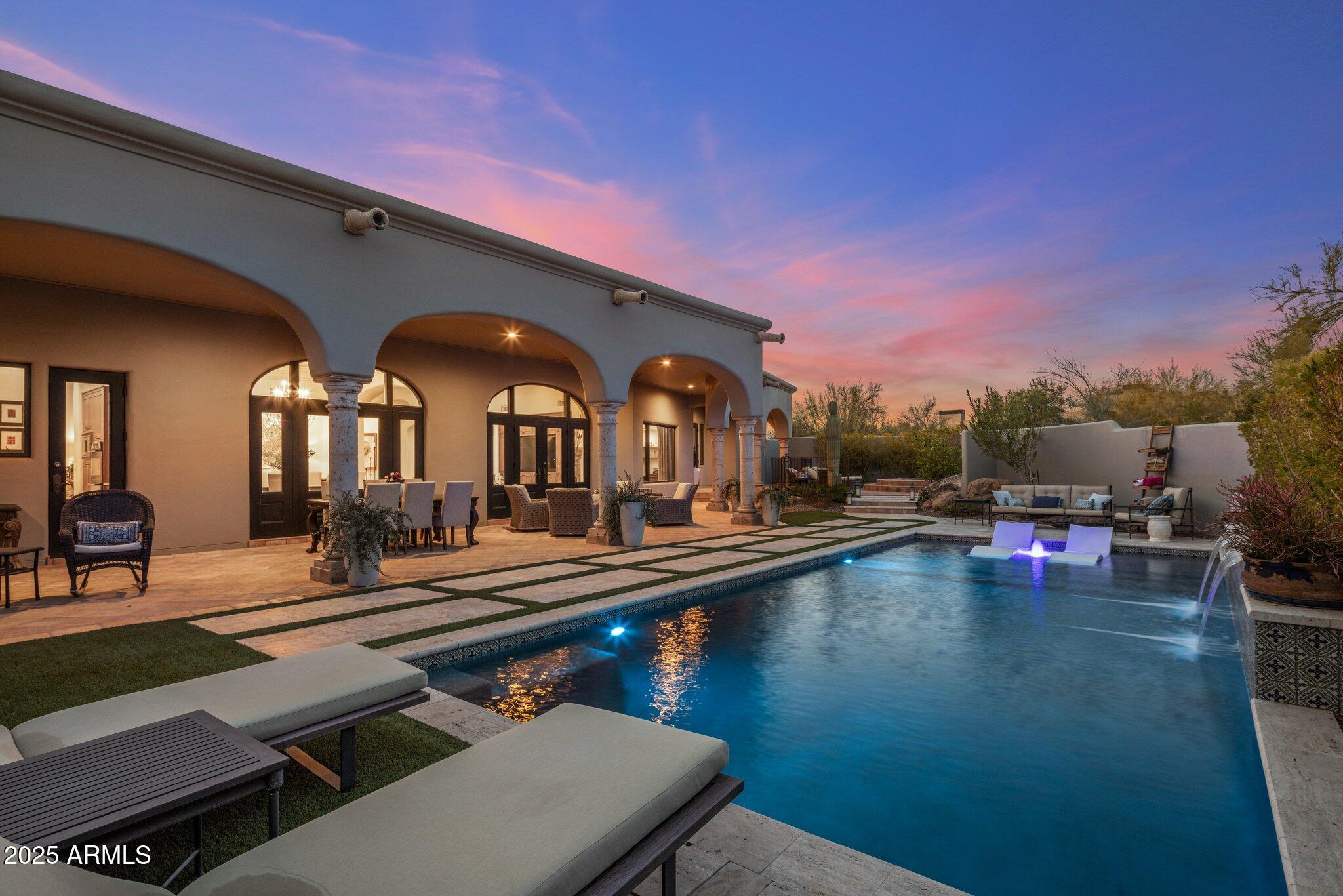 Close escrow in the morning and step into immediate GOLF MEMBERSHIP by afternoon. This stunning, turnkey Santa Barbara-style home seamlessly blends timeless elegance with modern sophistication. Designed for effortless living, the single-level layout features soaring ceilings, a spacious great room, and 3 ensuite bedrooms, plus a dedicated library/studyâ€”ideal for work or relaxation. At the heart of the home, the remodeled chef's kitchen is a showpiece, boasting Wolf and Sub-Zero appliances paired with quartzite slab countertops and backsplash, delivering both beauty and functionality. Step beyond the arched wood and glass-paneled doors to embrace true Arizona living in your private backyard oasis. A new swimming pool takes center stage, framed by breathtaking mountain views. This serene retreat is designed for entertaining or unwinding, featuring a heated spa, built-in barbecue, and an expansive covered patio for year-round enjoyment.  Located in the prestigious guard-gated community of Desert Highlands, this home provides exclusive access to a world-class lifestyle, complete with exceptional amenities and breathtaking surroundings.
-Jack Nicklaus Signature 18-hole championship golf course
-Gary Panks-designed 18-hole putting course
-State-of-the-art 7,700 sq. ft. fitness center
-13 tennis courts (clay, grass & hard surface)
-Pickleball courts, bocce ball courts, and a scenic walking/biking path meandering through the community
-Fishing pond, dog park, and more
As the day winds down, savor a relaxed meal at Jack's Pub or opt for an elevated dining experience at The Ventana.

Crafted by Nance Construction, this home epitomizes comfortable elegance, exceptional quality, and exquisite attention to detail. Whether you're seeking a full-time residence or a luxurious retreat, this property is a rare opportunity to own a piece of Desert Highlands paradise.