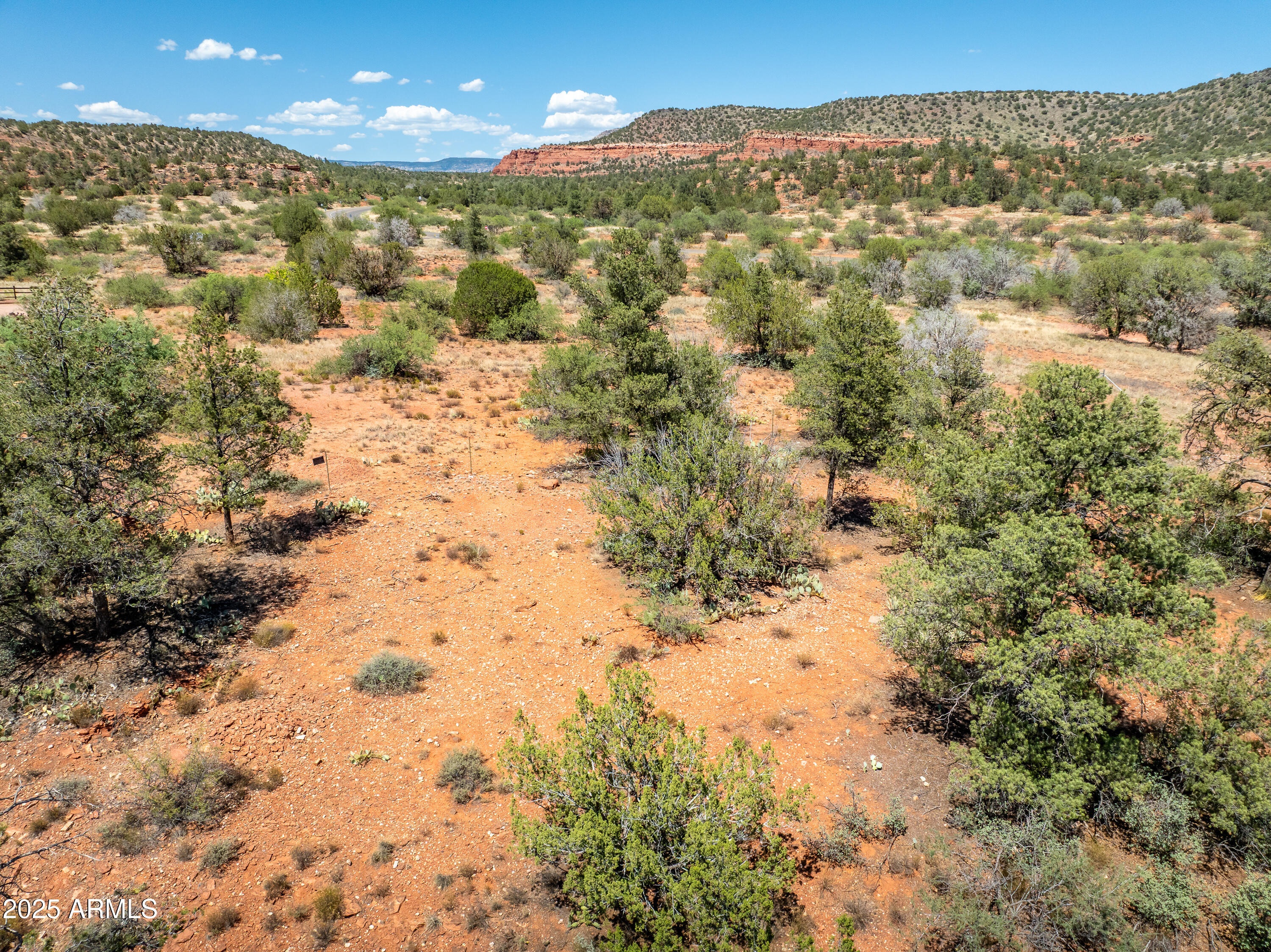 Ahhh, at last a spacious view lot that offers panoramic red rock vistas and a prime location a short distance to shopping, dining, and medical centers. No short-term rental restrictionsâ€”rare for this area! Builder plans & perk test availableâ€”ideal for ''buy now, build later.'' Easy access to Hwy 89A for commutes to other Verde Valley towns. Whether you envision a luxury residence, a vacation home, or an investment property, this lot provides the perfect foundation. Don't miss this chance to create your dream home in one of Sedona's most charming neighborhoods!