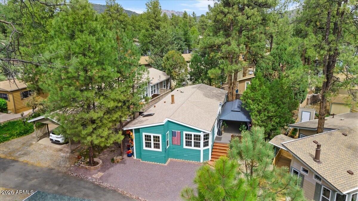 Imagine yourself relaxing in the pines enjoying your large, covered deck and escaping the 110 - 120 heat of the Phoenix Valley.  That's what you'd be doing if you owned this immaculate 3bdrm move-in ready home located in the 55+ community of Pine Lakes.
This home features: custom paint, vinyl plank flooring, waterfall basins, soft water, convection oven, large granite chef's kitchen with dual kitchen islands, custom window treatments, gas fireplace, Maytag washer, and dryer.  Just up the hill and through the walk-through gate you'll enjoy hundreds of acres of Prescott National Forest hiking and biking trails.  Community amenities include tennis, pickle ball, bocce ball, lakes and lake trails, picnic and BBQ areas, ping pong, horseshoes, dog park, car wash area, RV storage, rec center... workout room, pool, spa and more.  This is a special place.  Come and see for yourself!!! Owner Agent.