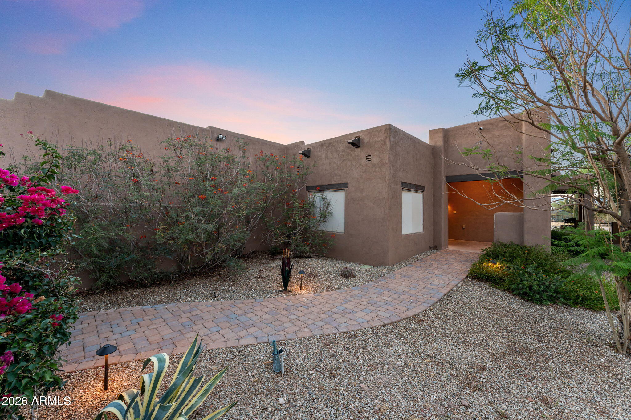 Own a slice of roper's paradise! This stunning property blends the best of luxury living with a top-of-the-line roping facility, all set against breathtaking views. Step inside this beautifully updated Santa Fe-style home, where charm and comfort harmonize perfectly. Rock fireplace creates a warm and inviting centerpiece for cozy nights. In the kitchen the gorgeous granite countertops, updated refrigerator, and many cabinets add sophistication and practicality. The Spanish style tile floors and wood accents & rock wall are finishes that showcase the exceptional craftsmanship of the home. The numerous entertainment spaces are perfect for hosting family and friends. The courtyard entrance and gate provide a stunning welcome with extensive landscaping, mature plant and trees with true Southwestern charm. Enjoy the Arizona sunsets, relax and unwind in your private heated pool. Ropers will love the professional arena equipped with sprinklers, roping chute and return alley. There is also a large turnout, steer pen, and 7 pens with covers misters and automatic waterers. There is a hay barn and tack room with a covered tie rack that will fit all your storage needs. For visitors there are two full RV hookups that will make hosting friends and family a breeze. The property is also fenced with steel pipe and no climb. This extrodinary property offers the ultimate balance of luxury living and equestrian excellence. Whether you're a professional roper, a weekend cowboy, or simply someone who appreciates the Western lifestyle, this is the place where dreams become reality. Come and experience firsthand why this roper's dream is truly one of a kind!