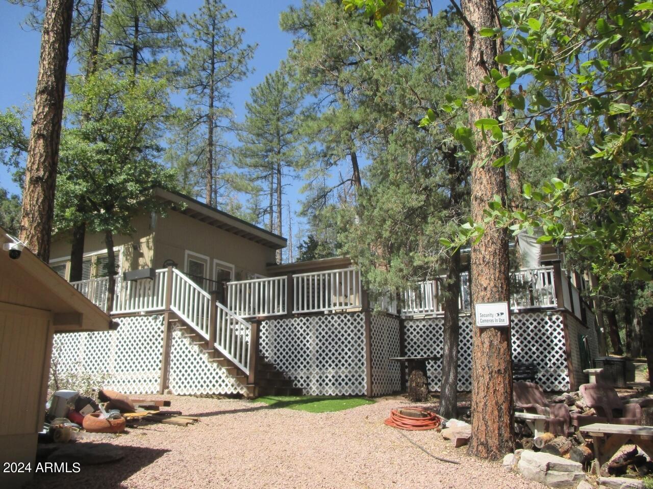 Great getaway cabin in the tall pines. Main home has 2BR/2BA with a family room, living room and extra large kitchen/dining area. Screened in porch to enjoy the cool evenings. The large windows in the living room along with the fireplace will make you want to grab a book and curl up.  The huge Trex deck can be accessed from the living room or master bedroom. Large fenced dog run. Extra building could be a guest house. Room adjacent to garage could have a variety of uses.  There is also a finished workshop. The home sits very private.  Peek-a-boo view of the Mogollon Rim.  Brand new $50K Alternative Septic System with 10 year warranty installed.  Home is being sold furnished - just bring your clothes!