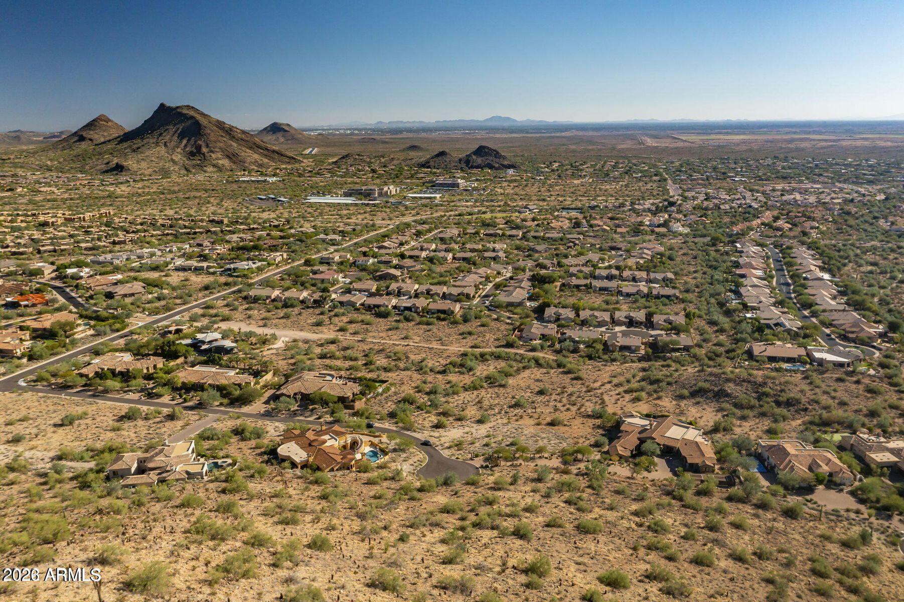 Set on more than 2 elevated hillside acres in a quiet cul-de-sac, this exceptional homesite offers sweeping McDowell Mountain and city light views. Ideally located near Mayo Clinic, BASIS and top Scottsdale amenities, the property includes architectural plans for a 5 bed, 5.5 bath custom estate designed for refined desert living. The proposed residence features a private guest suite, spacious chef's kitchen, formal and casual dining, multiple living areas, bonus entertainment room and wine cellar, with options for a theater and elevator. A rare opportunity to build a luxury estate in a prime Scottsdale setting.