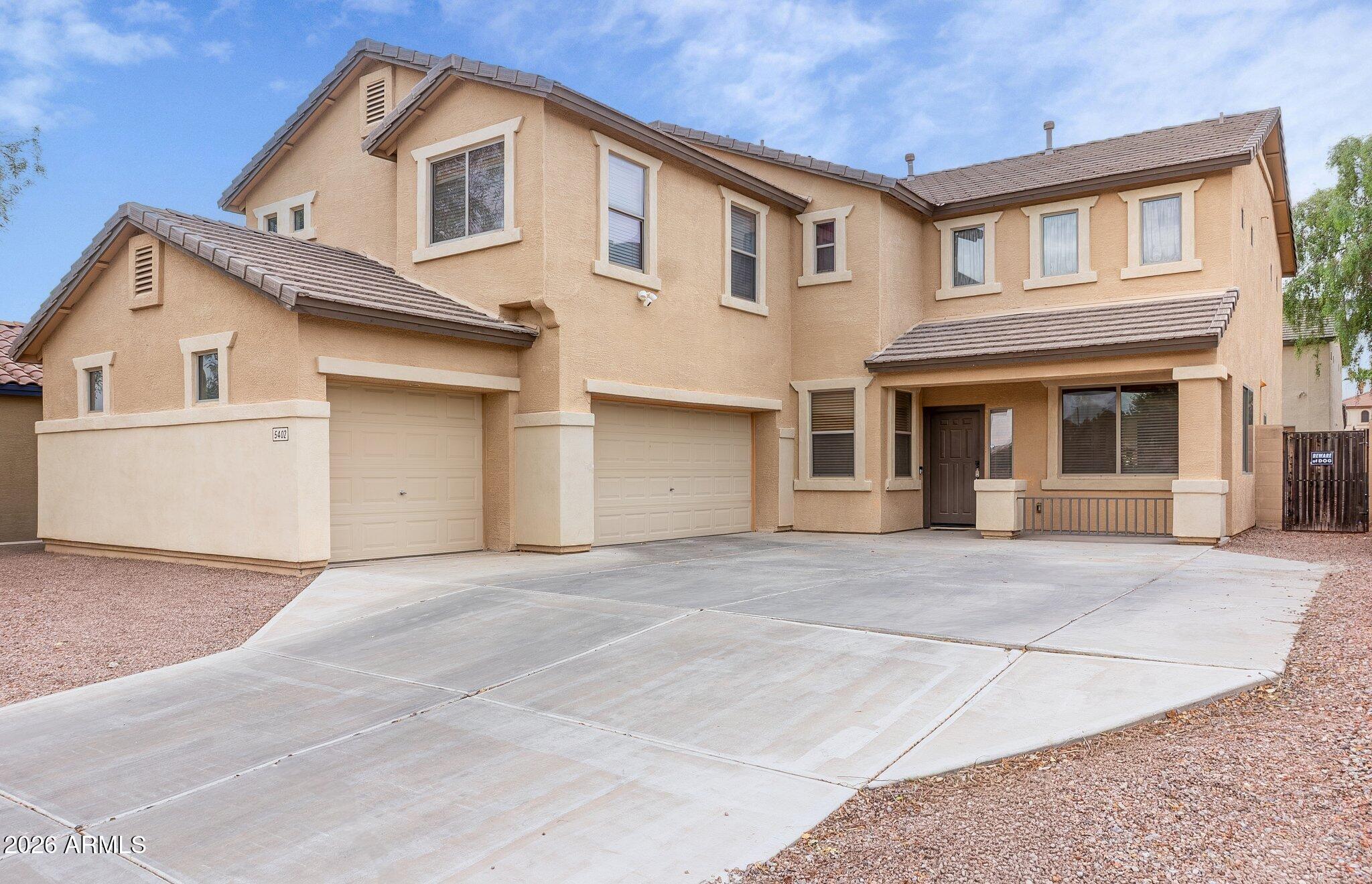This is a GEM of home in the highly sought-after neighborhood of Wigwam Creek North. The spacious and desirable floor plan includes 4 bedrooms, a loft, a den, and 2.5 baths. The beautifully maintained kitchen features stainless steel appliances. The dining room flows into an impressive living area with soaring ceilings of over 20 feet. The master bedroom is generously sized and boasts a HUGE walk-in closet. The garage features epoxy flooring and a designated work area. The backyard offers a covered patio and a well-maintained grassy area. Plus, it's only three houses away from a neighborhood park with basketball courts and plenty of play equipment for family enjoyment!
