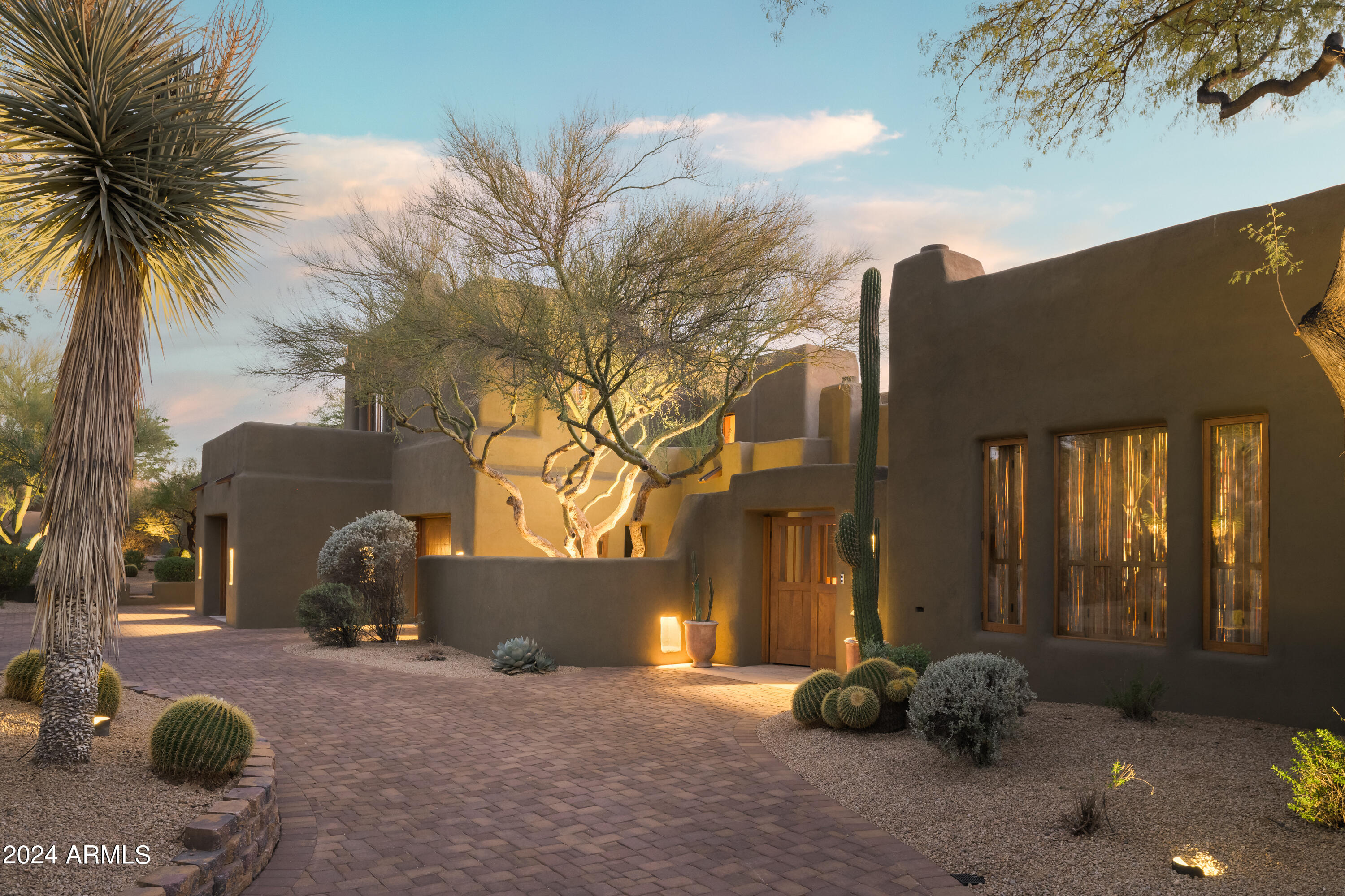 Discover one of Bill Tull's finest works of art in the beautiful Boulders community. 

Discerning buyers will appreciate the attention to detail that only an authentic adobe home built by Bill Tull can provide. This private retreat spans two lots and features three guest casitas, 13 fireplaces, a sauna, a 200+ bottle wine cellar, golf cart garage, massive viga beams, expansive latilla ceilings, saguaro rib window treatments, hand-carved woodwork, countless niches, flagstone flooring, and one of Bill Tull's most thoughtfully designed kitchens.

The home is authentic adobe, meaning it was constructed with handmade solid bricks from the earth surrounding the property. The result is a home built with exceptional quality and care, boasting unparalleled efficiency for the desert climate. This home has been meticulously maintained by one owner, a close friend of Bill Tull, and represents one of his last completed projects.

The property is golf-course adjacent, incredibly private, and offers scenic mountain views from the upper patios. A golf membership at the Boulders Golf Club, a golf cart, and most all furniture, furnishings, and artwork are available through a separate bill of sale.

This is your opportunity to own a truly exceptional home.