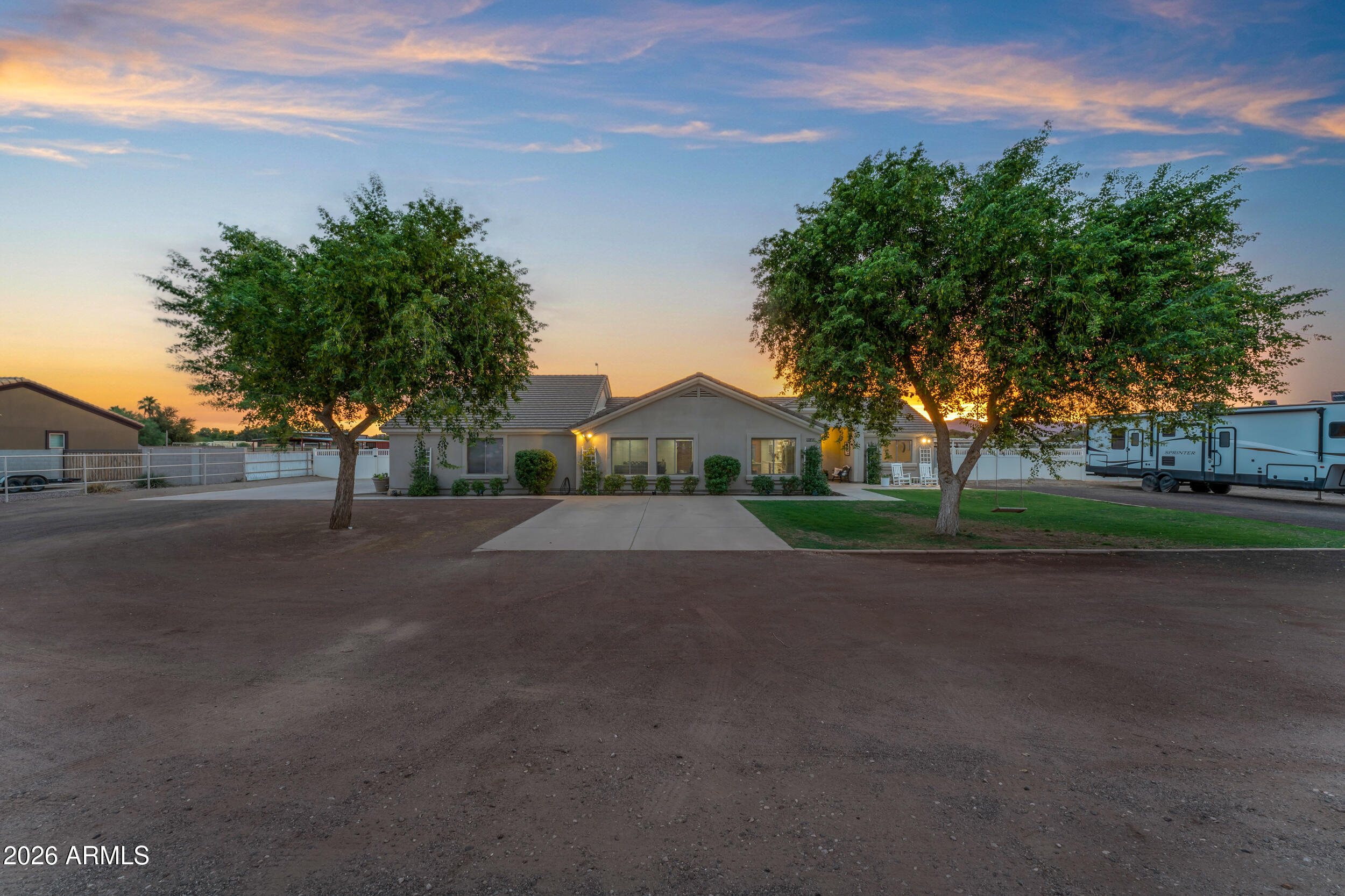 SPECTACULAR Sunset Views! Spacious home on an acre and a quarter flood irrigated land. No HOA! The lush trees and grass surround the property while backyard opens to 30 more acres of pasture! Truly breathtaking! Fully remodeled home with 2 En-suites, 3 full baths and air conditioned room off the garage for a mancave, a craft room or bedroom.  HUGE OPEN Floor Plan! Gourmet kitchen includes new Verona Range, RO water, pot-filler, LG refrigerator and dishwasher, Loads of Storage, Open Shelving and Custom Moveable Island. Beautiful Engineered stone and Recessed Lighting throughout. Kitchen extends to both front Living area as well as Family Great Room. High End Surround Sound Speakers, Smart Lighting and Gorgeous wood-look tile throughout open areas makes the space Open and Inviting! 400 amp panel and RV hookup for new HUGE building in back. Could be used for wood shop, she-shed or extra living space! Pipe in place for power and water to back shed and extra concrete meant for hot tub under the stars! Massive possible parking options for toys, RVs or vehicles. Back Patio extends the length of the home. Horse coverings in back and 2 RV vinyl gates make this estate truly special. And don't forget the freshly epoxied garage floor. One of the BEST VIEWS in Waddell. Come see for yourself!