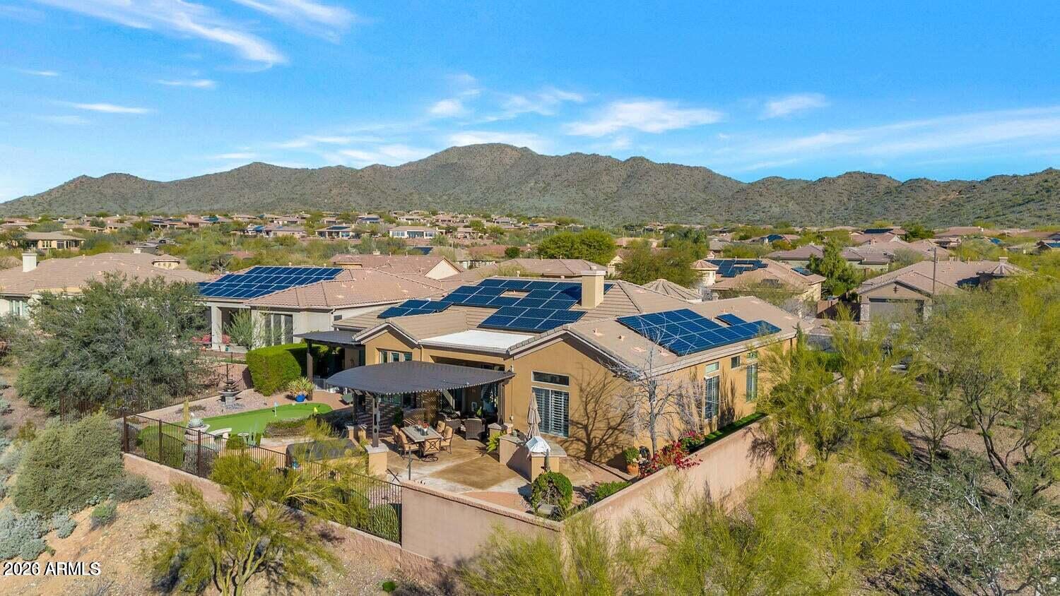 Welcome to luxury living in Anthem Golf & Country Club. This highly sought-after Monterey model is perfectly positioned on an elevated lot with breathtaking mountain views and stunning Arizona sunsets. A brick paver driveway, private courtyard, custom iron front door, and elegant marble foyer create a memorable first impression. Inside, you'll find custom built-ins, plantation shutters, designer lighting, a Murphy bed, and extensive granite throughout. The expanded kitchen features custom seating, a designer backsplash, and abundant entertaining space. The owner's retreat offers an updated walk-in shower and spacious closet. Outdoors, enjoy a pergola, putting green, and tranquil backyard. Owned Tesla solar panels and a Tesla charging station complete this move-in-ready home. Experience the extraordinary lifestyle of Anthem Country Club, a prestigious guard-gated community nestled in the scenic foothills of Daisy Mountain. Residents enjoy two championship golf courses, 36 holes of award-winning golf, two elegant clubhouses, resort-style pools, state-of-the-art fitness centers, tennis, pickleball, bocce ball, and exceptional dining. Surrounded by breathtaking mountain vistas, lush fairways, and spectacular Arizona sunsets, Anthem Country Club offers a perfect blend of luxury, recreation, and community. A vibrant social calendar, world-class amenities, and beautifully maintained grounds create an unparalleled living experience. Discover why Anthem Country Club is one of Arizona's most sought-after private country club communities, where every day feels like a vacation.
