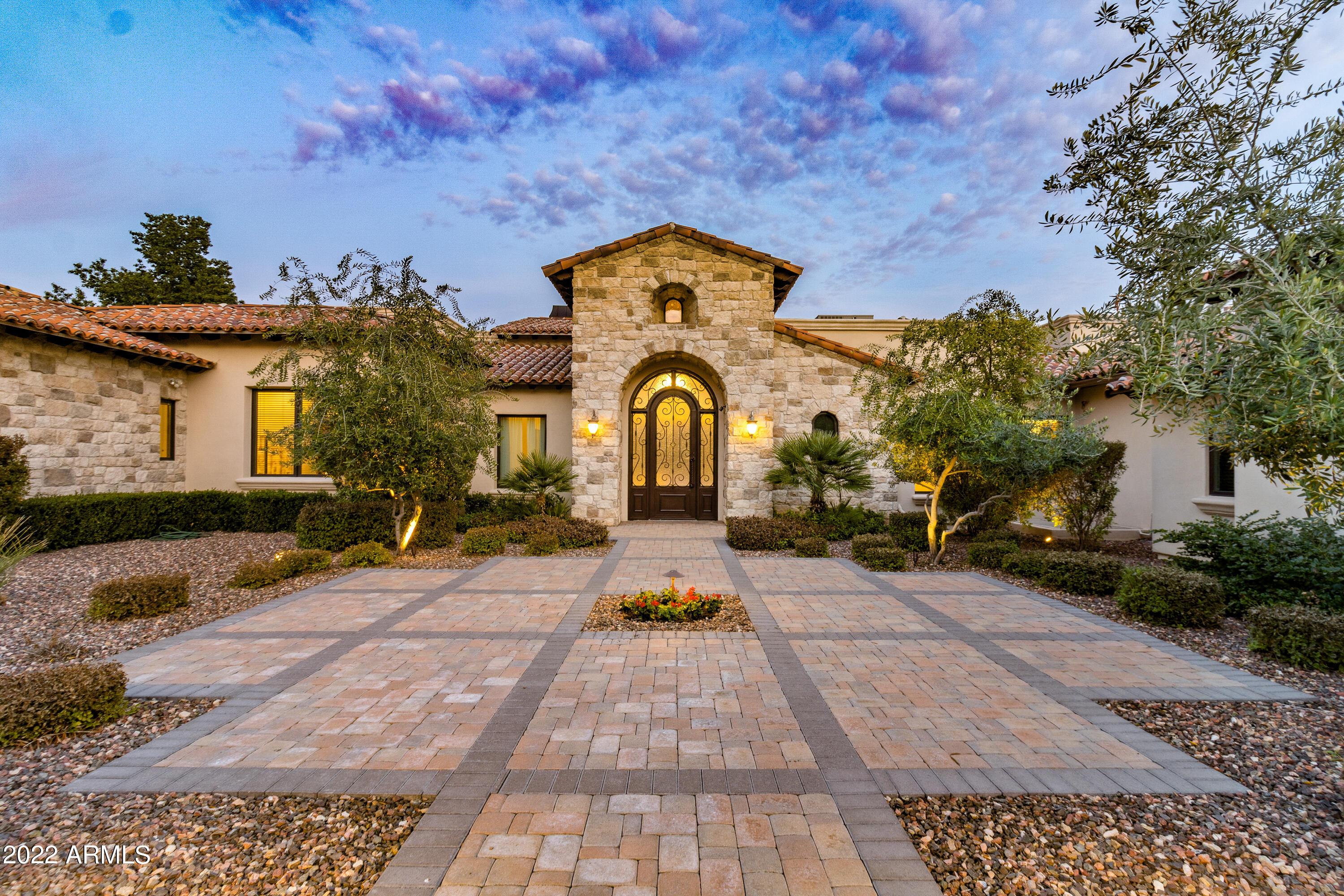 Welcome to 7807 N. Calle Caballeros, a stunning Paradise Valley estate nestled in the heart of one of Arizona's most desirable neighborhoods. This luxurious property boasts over 9,400 square feet of living space, featuring 5 bedrooms, 7.5 bathrooms, and a spacious 4-car garage.

Upon arriving at this expansive estate, you'll be greeted by a beautiful courtyard full of lush landscaping. As you enter through the iron gates and make your way to the front door, you'll be immediately struck by the grandeur of this property. The courtyard sets the tone for the luxurious living experience that awaits you inside. As you step through the front door and into the grand foyer, you'll be greeted by the breathtaking views of this beautiful home and unrivaled backyard oasis. The main level features a formal living room with a stunning stone fireplace and beautiful wood beams that span the ceiling. Adjacent to the living room is an elegant bar, perfect for mixing up cocktails for your guests. The formal dining area is stunning and adds to the impressive great room of this home.  The gourmet kitchen with top-of-the-line appliances, exotic granite countertops, and two oversized islands is a chef's dream. The kitchen flows seamlessly into the family room, which boasts gorgeous views and access to the backyard. You'll love spending time in these elegant spaces, whether you're entertaining guests or simply relaxing with your family.

As you make your way down the grand hallway into the dedicated home office, you'll be struck by the beautiful built-in wood bookcases that line the back wall. These bookcases provide ample space for storing your books, documents, and other office essentials, and they add a touch of warmth and sophistication to the space. The office itself is spacious and well-lit, with plenty of natural light. Whether you're working from home or simply need a quiet place to focus, this home office is the perfect space to get things done.

The generous master suite is complete with a sitting area, fireplace, and a spa-like bathroom with a jetted tub and dual vanities. As you enter the custom closet, you'll be greeted by rows of custom shelving, drawers, and hanging space, all designed to hold your clothing, shoes, and accessories. The closet features warm lighting, making it easy to see and access your items. You'll love the ample space this closet provides, with room for everything you need and more.

There are four additional bedrooms on this level, each with their own private bathroom. These bedrooms offer plenty of space and comfort for you and your guests, making them the perfect retreat after a long day. Each bedroom has been thoughtfully designed, with plenty of storage and natural light. The private bathrooms feature modern fixtures and finishes and are well-equipped with all the amenities you need. Whether you're hosting overnight guests or simply need extra space for family and friends, these additional bedrooms offer the ultimate in comfort and convenience. You'll love the privacy and flexibility they provide, and your guests will appreciate the attention to detail and comfort of their own private retreat.

The backyard of this Paradise Valley estate is an entertainer's dream, with a sparkling infinity edge pool and spa, a built-in BBQ and pizza oven, and an expansive covered patio perfect for al fresco dining. The pool is surrounded by lush landscaping and a spacious travertine deck, making it the perfect spot to soak up the Arizona sun. The hot tub, located in the far edge of the pool, offers a soothing respite after a long day or a refreshing start to your morning. Both the pool and hot tub are heated, ensuring you can enjoy them all year round. With these luxurious amenities, you'll feel like you're on a permanent vacation in the comfort of your own home.

In addition to the amenities mentioned, this estate also features a private shooting range and safe room for the ultimate in security and recreation. The shooting range is vented & climate-controlled, offering a safe and enjoyable space for target practice or recreational shooting. The safe room is the perfect place to retreat to in the event of an emergency, with reinforced walls and security features.

For the wine connoisseur, this home also boasts a temperature-controlled wine cellar, capable of storing and showcasing your finest vintages. And when it's time to relax, you can head to the home theater, complete with comfortable seating and full audio and visual systems. Whether you're hosting a movie night with the family or inviting friends over for a private screening, the theater is the perfect spot to kick back and enjoy your favorite films.

In addition, there is a home gym/yoga studio, as well as a sauna & steam shower, providing the ultimate in relaxation and wellness. 

This exceptional estate is located in the heart of Paradise Valley, close to top-rated schools, shopping, dining, and entertainment. Don't miss out on the opportunity to call 7807 N. Calle Caballeros your forever home.