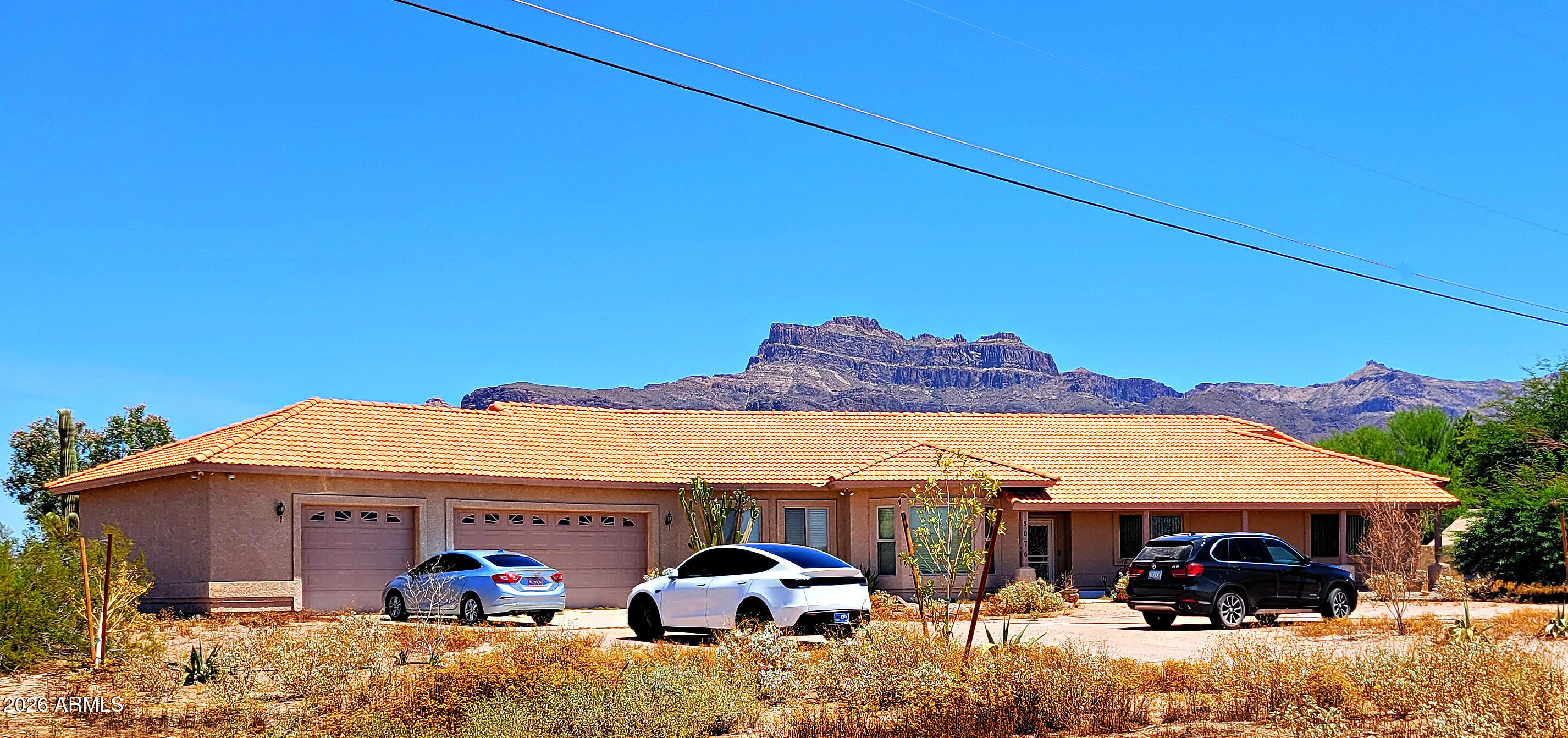 Bring Your RVs, Horses & Hobbies - No HOA! Resort-Style Living on 2.5 Acres with Breathtaking Mountain Views!
Escape the ordinary and discover the perfect blend of Luxury, Privacy, and Wide-open Space on this Incredible Estate featuring Stunning Mountain Views, a Private Well, and endless room for all your toys, animals, and Outdoor Adventures.  This beautifully appointed single-level 4-bedroom, 2-bath Home welcomes you with soaring ceilings, elegant arched doorways, rich wood flooring, and thoughtfully designed living spaces. The spacious Gourmet Kitchen is a dream for entertaining, offering abundant cabinetry, a large walk-in pantry, and Stainless Steel appliances.  Retreat to the oversized primary suite with a huge walk-in closet and a beautifully finished spa-inspired bath featuring.. a Separate soaking tub and beautifully tiled shower. Additional upgrades include multi-zone A/C with air returns in every room, pre-wired sound, and expansive covered front and rear porches where you can savor spectacular sunrises with your morning coffee and unforgettable sunsets in the evening.
Step outside to your own Private Oasis featuring a Saltwater Pool and Spa, perfect for Relaxing, Entertaining, or Enjoying Arizona's Beautiful Weather year-round.
Adding even More Value and flexibility is the Separate 1-bedroom, 1-bath Guest House, ideal for Multigenerational Living, Extended Family, Guests, or potential Rental Income.
The Property is Complete with Low-Maintenance Landscaping on an automatic watering system and plenty of Room for RVs, Trailers, Horses, Workshops, and All Your Favorite Hobbies--with No HOA Restrictions to limit your Lifestyle.
Rarely does a property offer this much Space, Versatility, and Resort-style Amenities with such Incredible Views. If you've been searching for room to breathe and a place to truly make it your own, your Search Ends Here. Plan your Preview Today!
