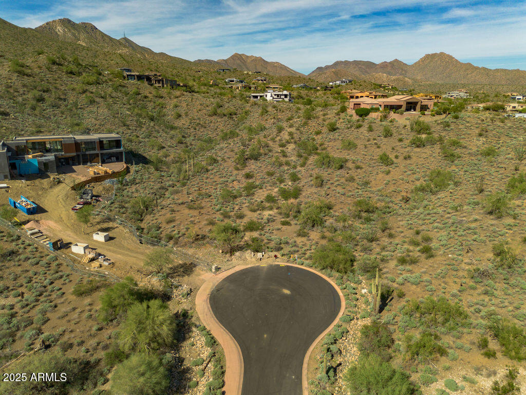 Sited at the quiet end of a private cul-de-sac, this elevated 1.6-acre parcel in the guard-gated community of Eagles Nest offers the perfect backdrop for an exceptional custom estate.  A generous building envelope captures sweeping Sonoran Desert panoramas, dramatic mountain vistas and sparking city-light views.  The oversized lot provides design flexibility and privacy, with untouched natural desert and majestic saguaros framing the landscape. Enjoy the tranquility and open space of Fountain Hills living, while still being moments from hiking trails, championship golf, and convenient access to both Fountain Hills and Scottsdale amenities.