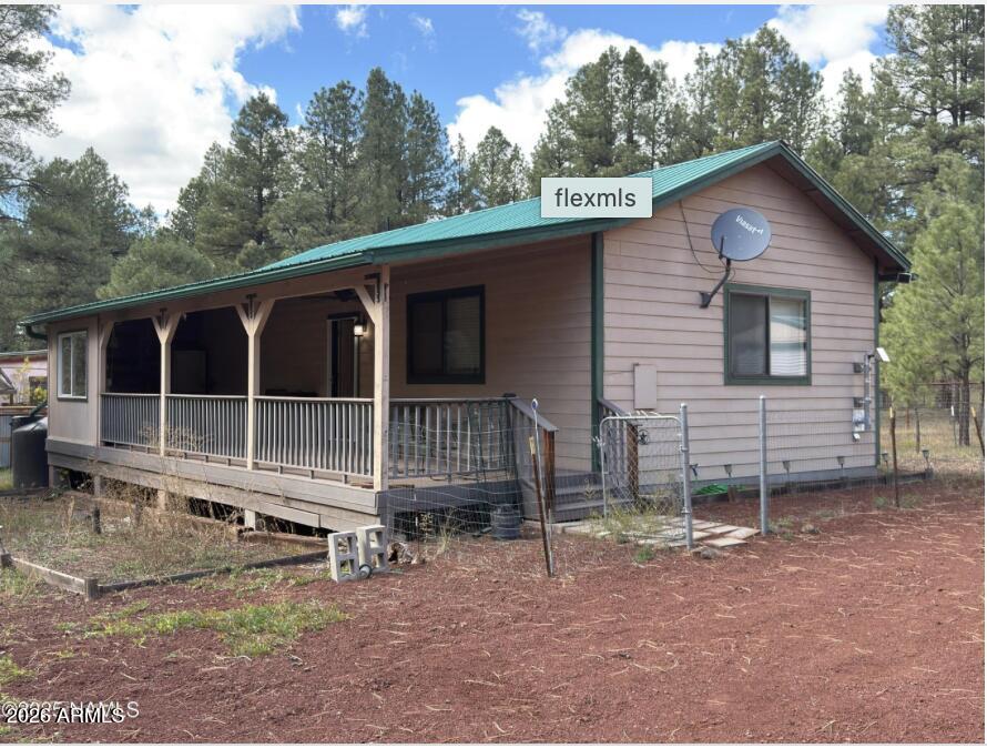 Bring your family, bring your friends, load up your horses and escape the Phoenix summer heat. This property is located in the desirable Sherwood Forest with beautiful trees for cooler weather and scenery. Featuring 3 separate dwellings, the main home is a 1 bedroom, 1 bath. The front guest home features a kitchenette, full bathroom, and a loft. The back guest home has a 1/2 bath and plenty of sleeping room. This would be a great summer home, minutes away from the Deer Farm, Bearizona and the Grand Canyon.
