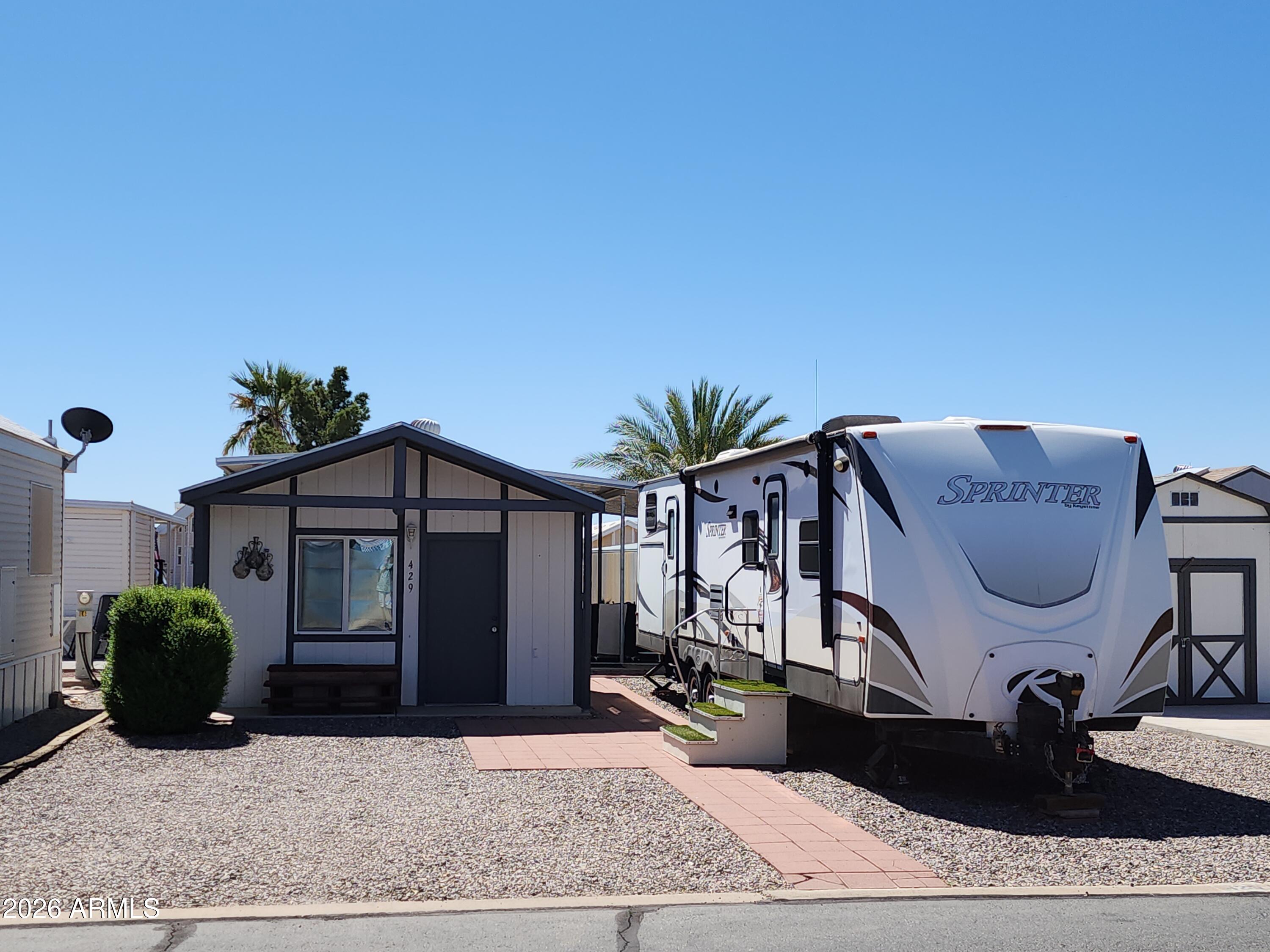 Great lot in the sought-after 55+ community -Tierra Del Sol RV park, in the safest small city in Arizona (2025) Florence AZ, where you own your own land so no lot rent. The purchase includes the lot that is 37' X 49' graveled lot with pavers for patio and walkways. Also included is a 2014 Keystone 36' Travel-Trailor that will convey to buyer at COE. The RV has an indoor kitchen as well as an outside kitchen when you move the party to the patio. Also included, a very nice 11' x 15' shed and new electrical additions, finished interior walls that have been insulated. All RV hook ups: electric post, water, and sewer are on the property. Tierra Del Sol has a large club house and a walled off pool with spa. A memorial garden for our servicemen and much more. The golf course is just up the street